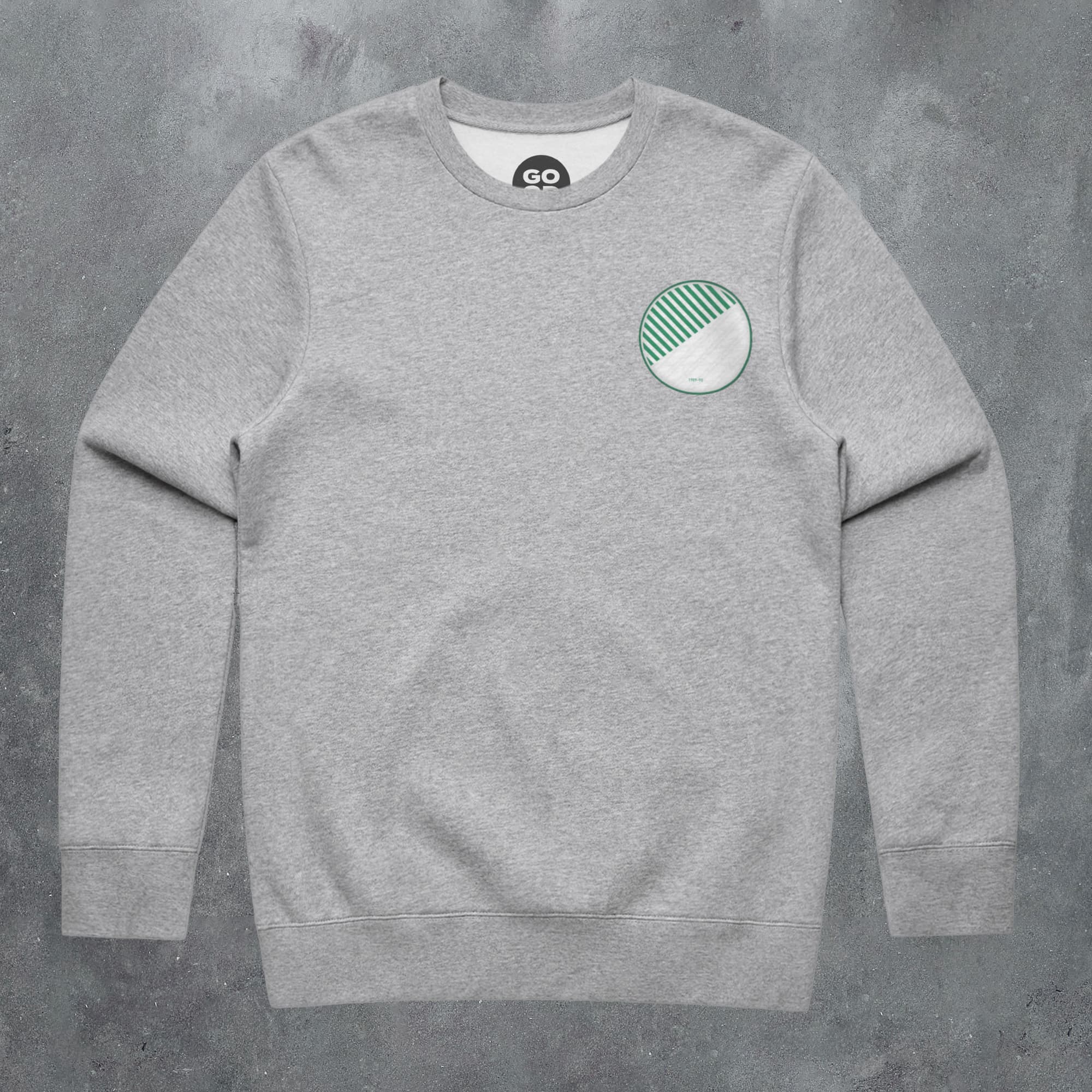 a grey sweatshirt with a green and white patch on the chest