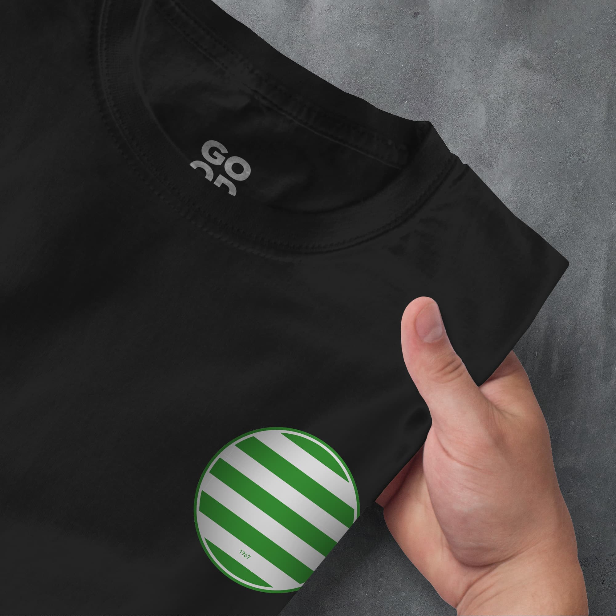 a person holding a green and white striped shirt