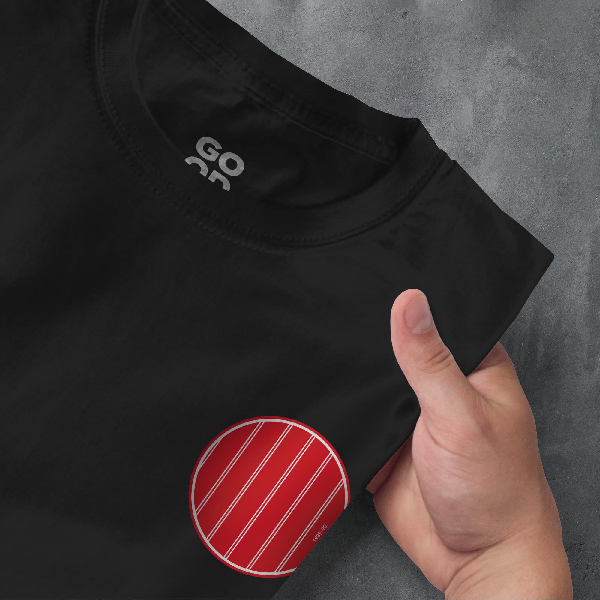a person pointing at a red and white striped t - shirt