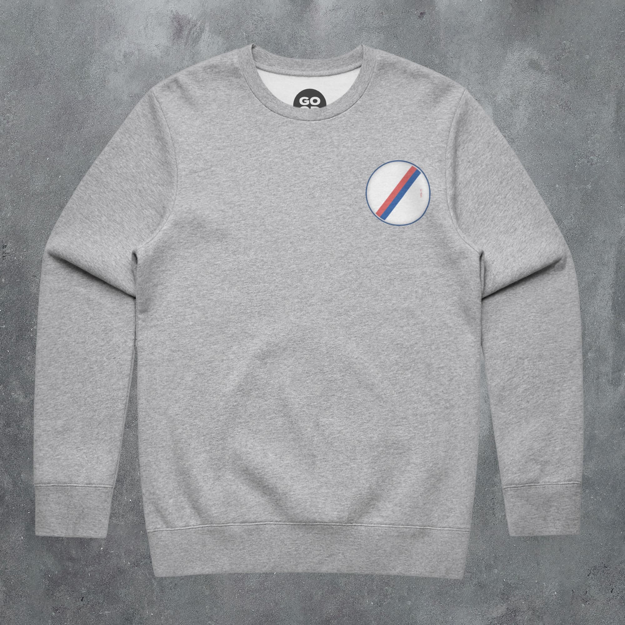 a grey sweatshirt with a white, blue, and red stripe on the chest