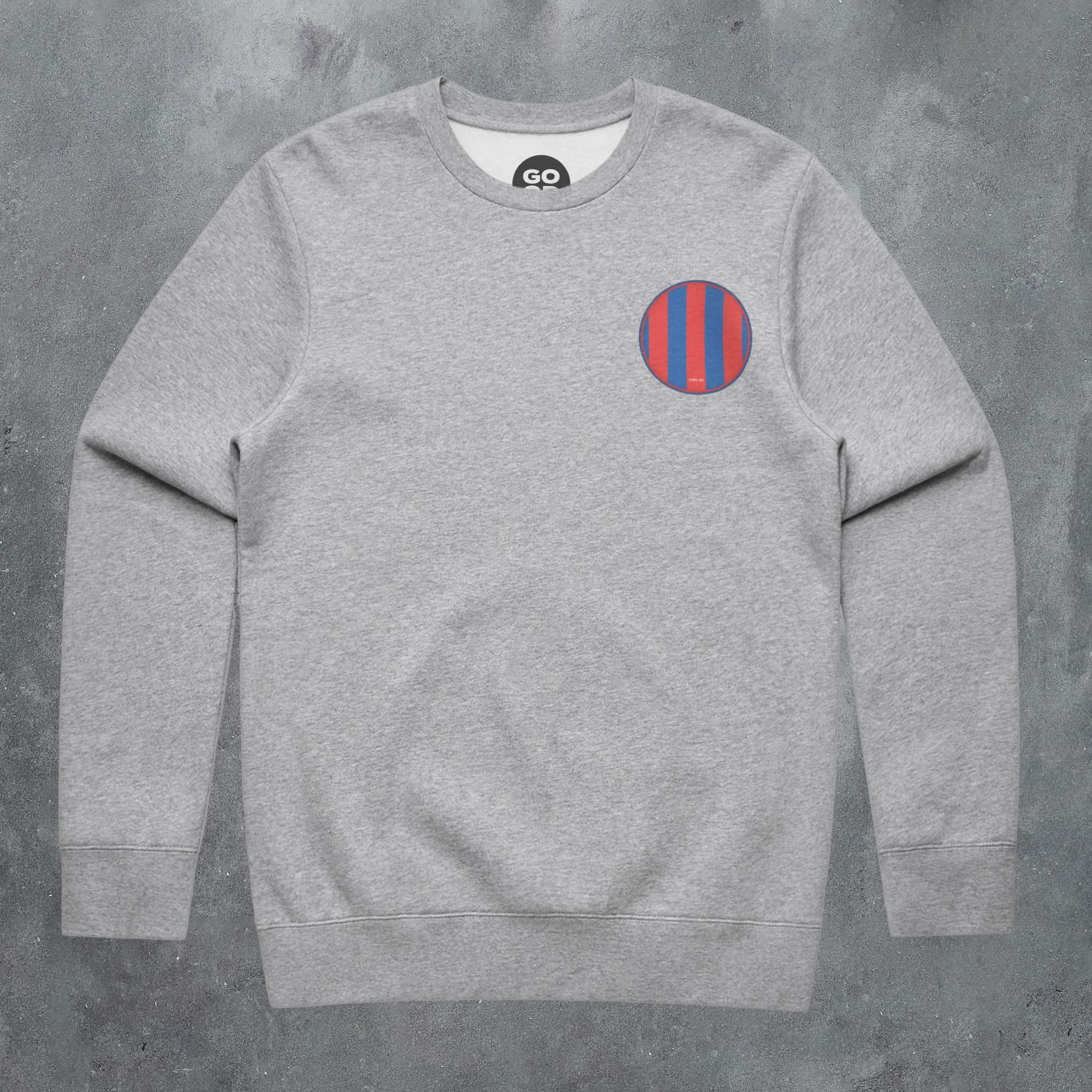 a grey sweatshirt with a red and blue stripe on the chest