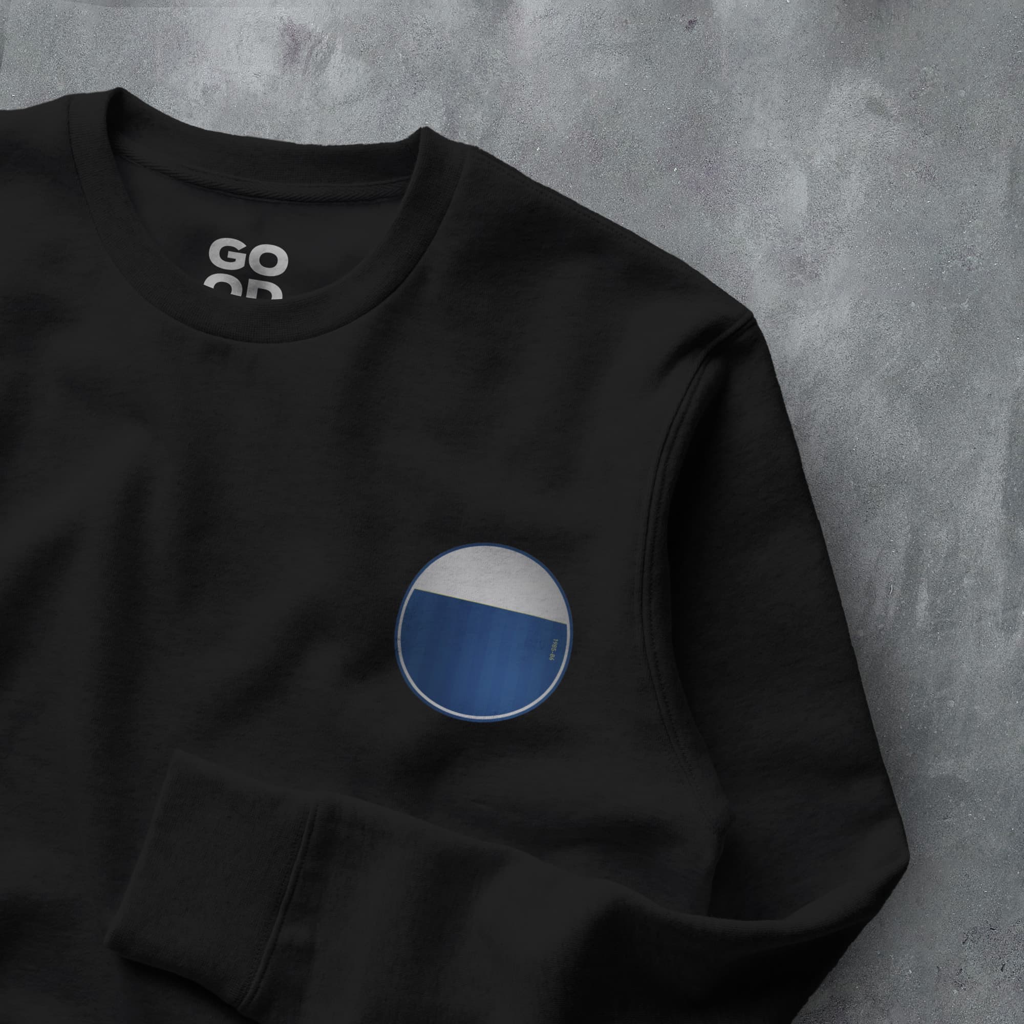 a black sweatshirt with a blue circle on it