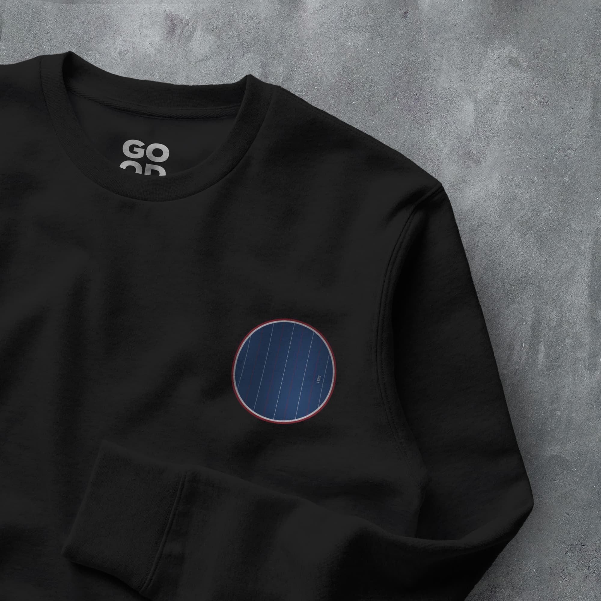 a black sweatshirt with a blue circle on it