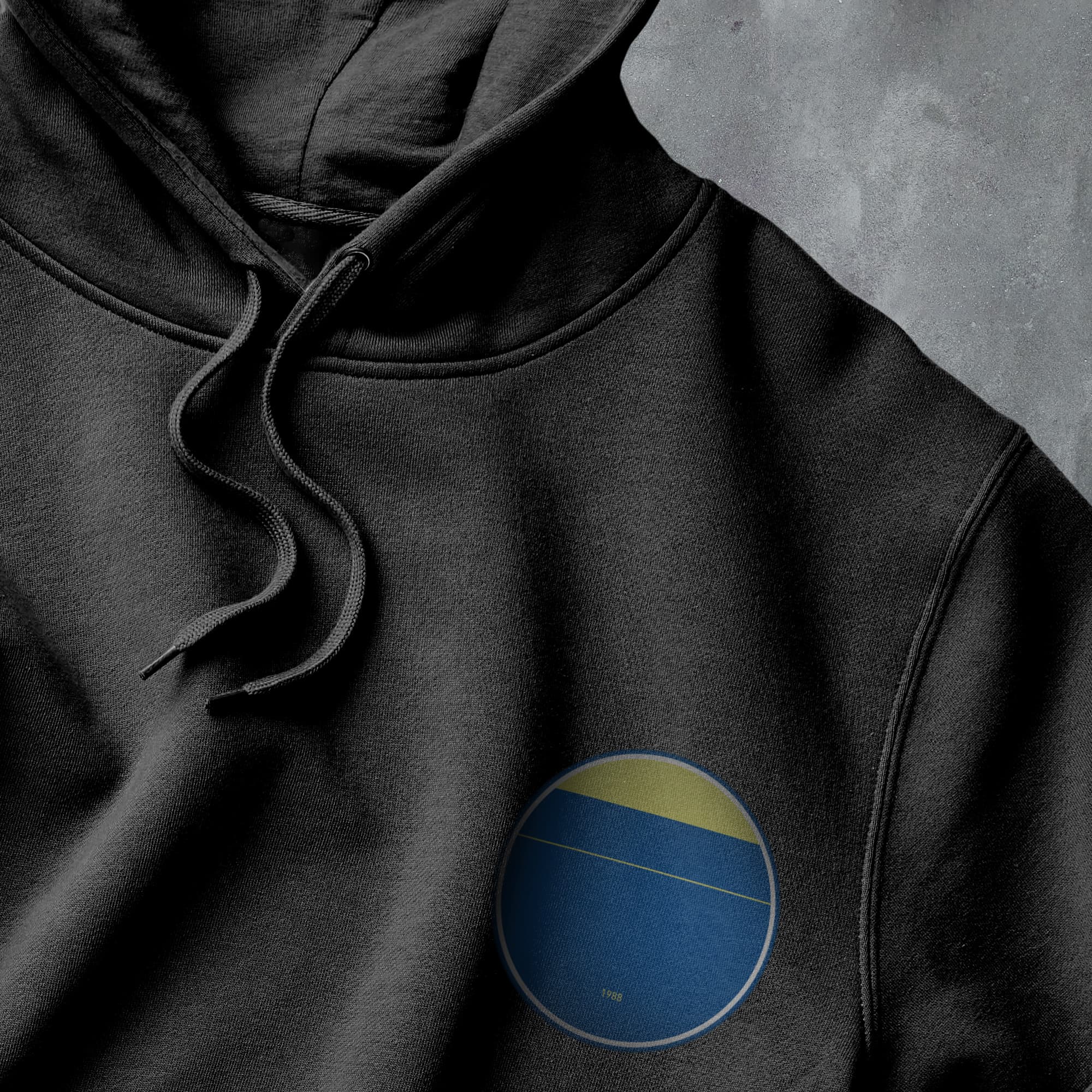 a black hoodie with a blue and yellow circle on it