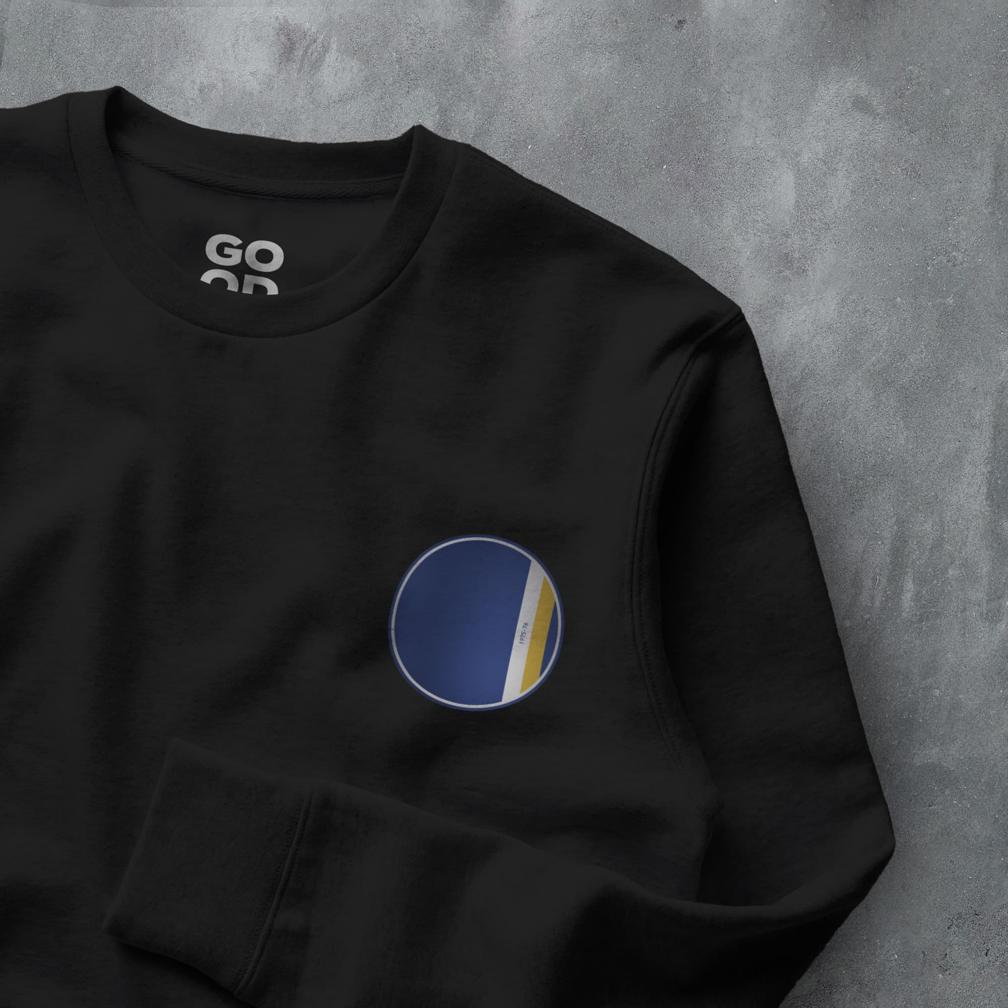 a black sweatshirt with a blue and yellow circle on it