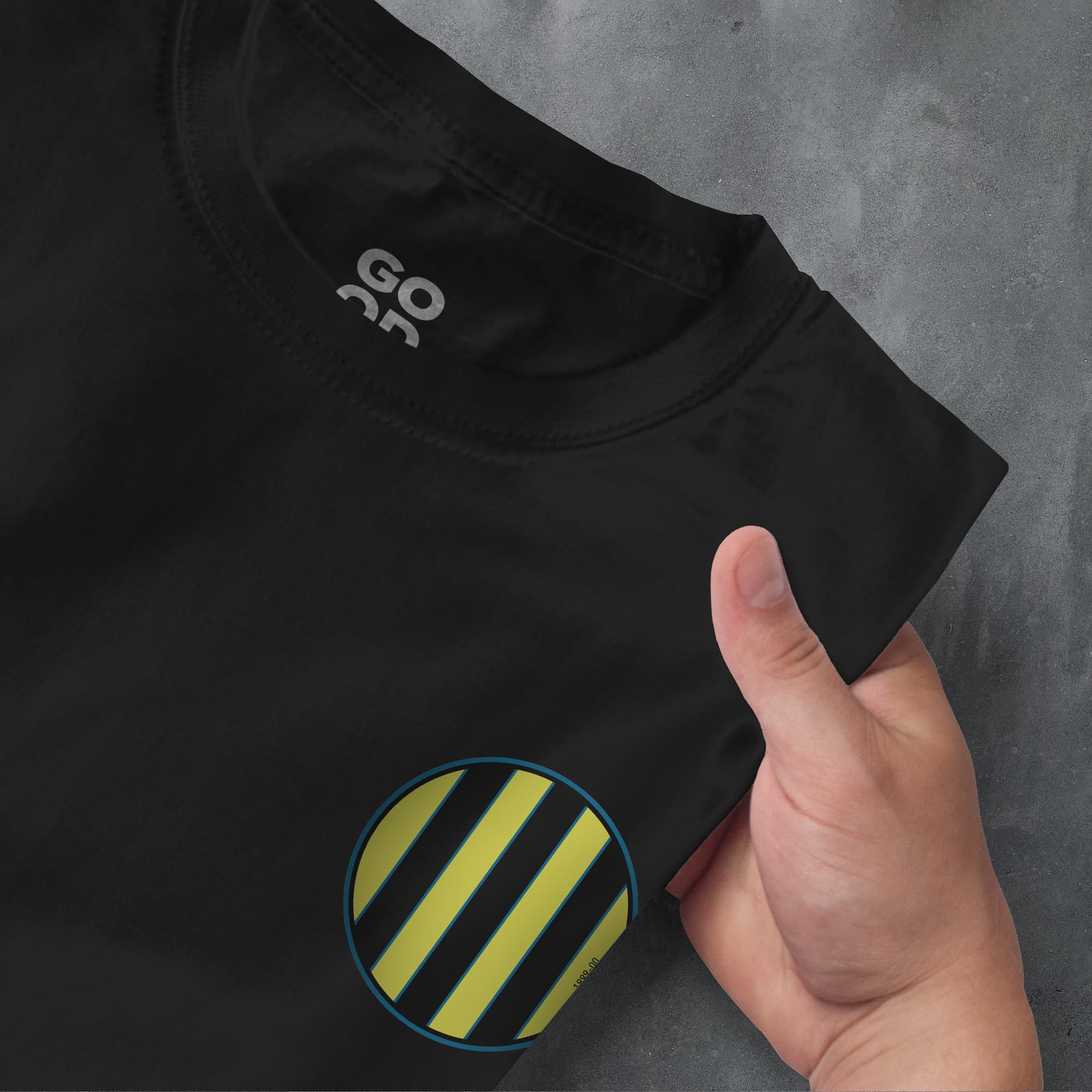 a hand pointing at a black shirt with yellow and black stripes