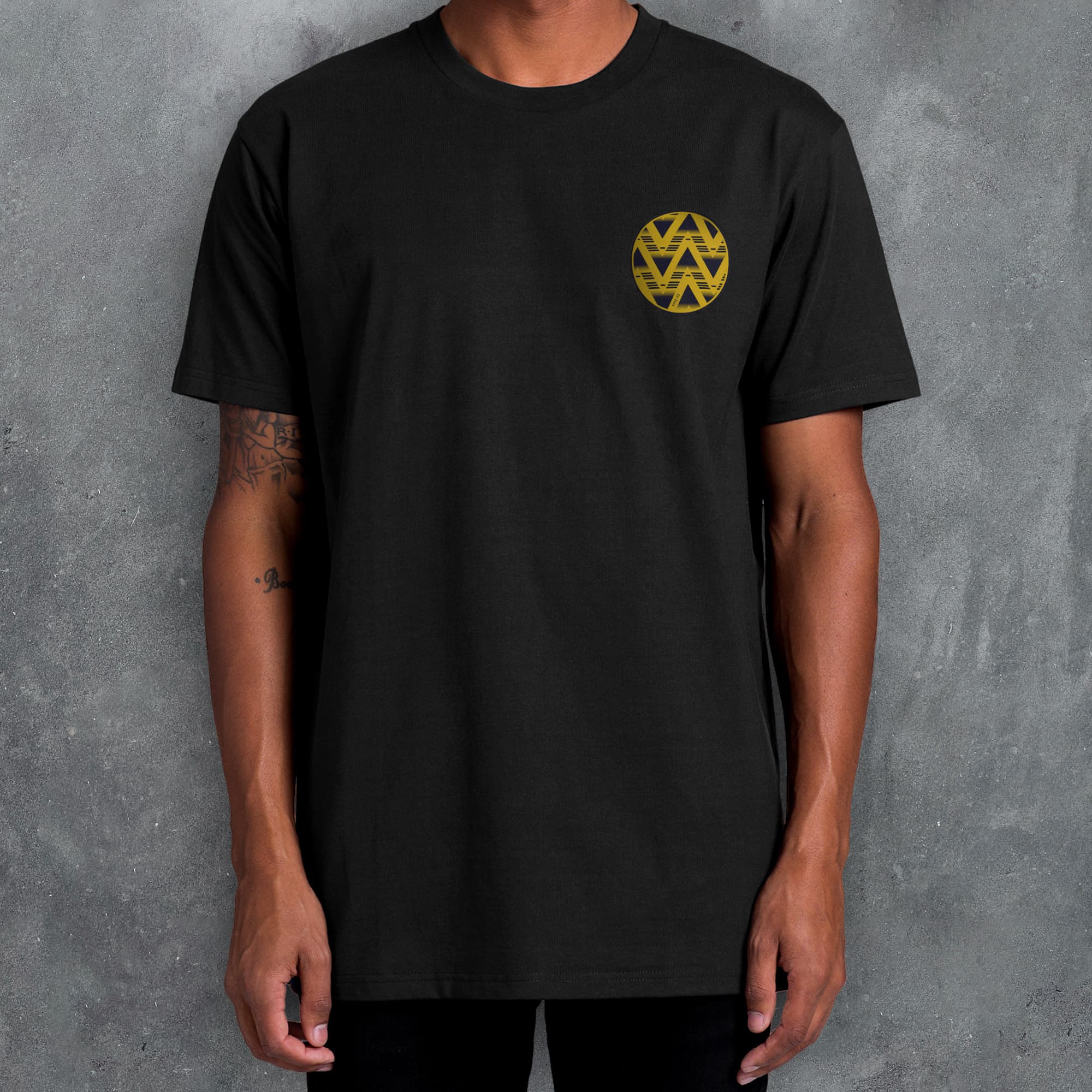 a man wearing a black t - shirt with a yellow heart on it