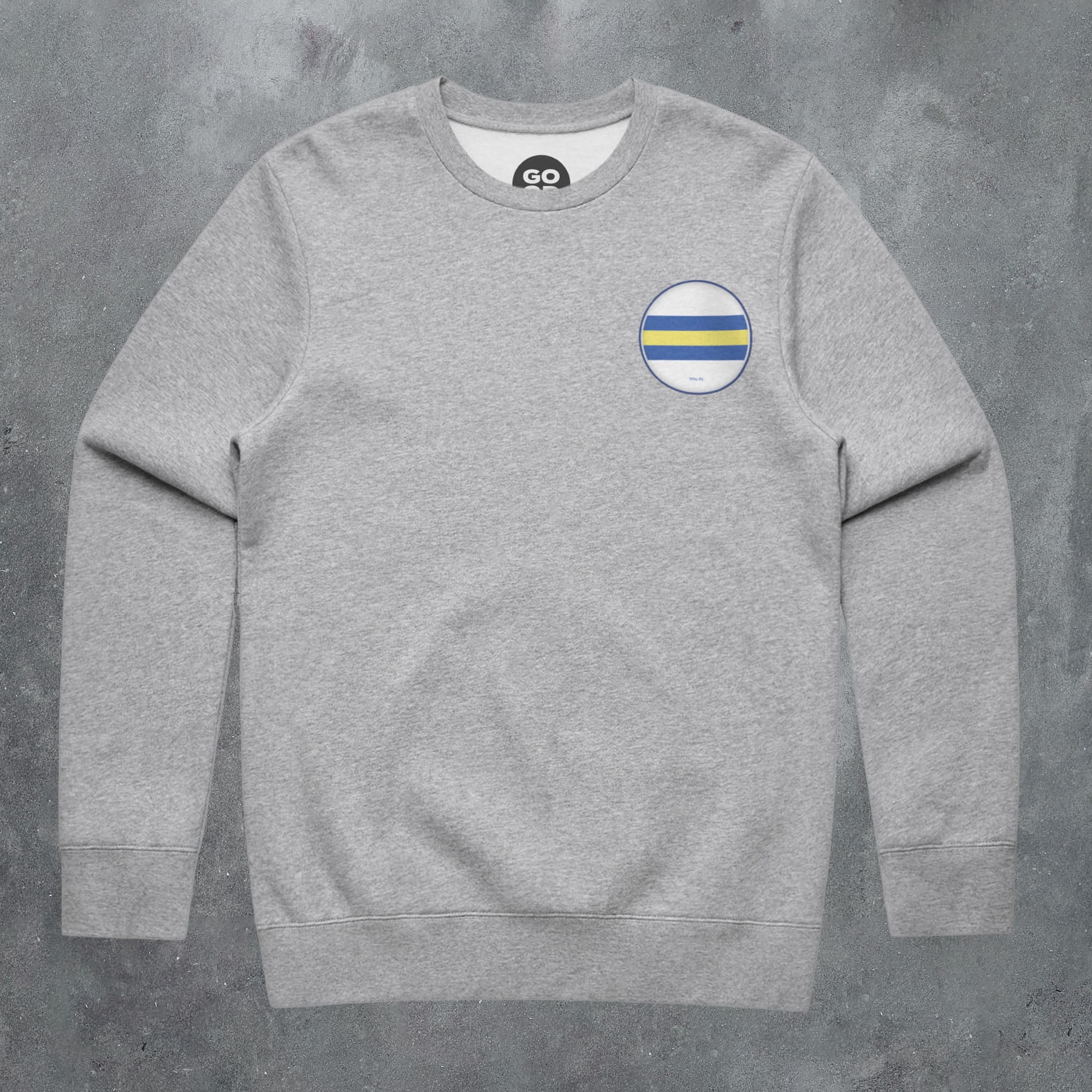 a grey sweatshirt with a yellow and white stripe on the chest