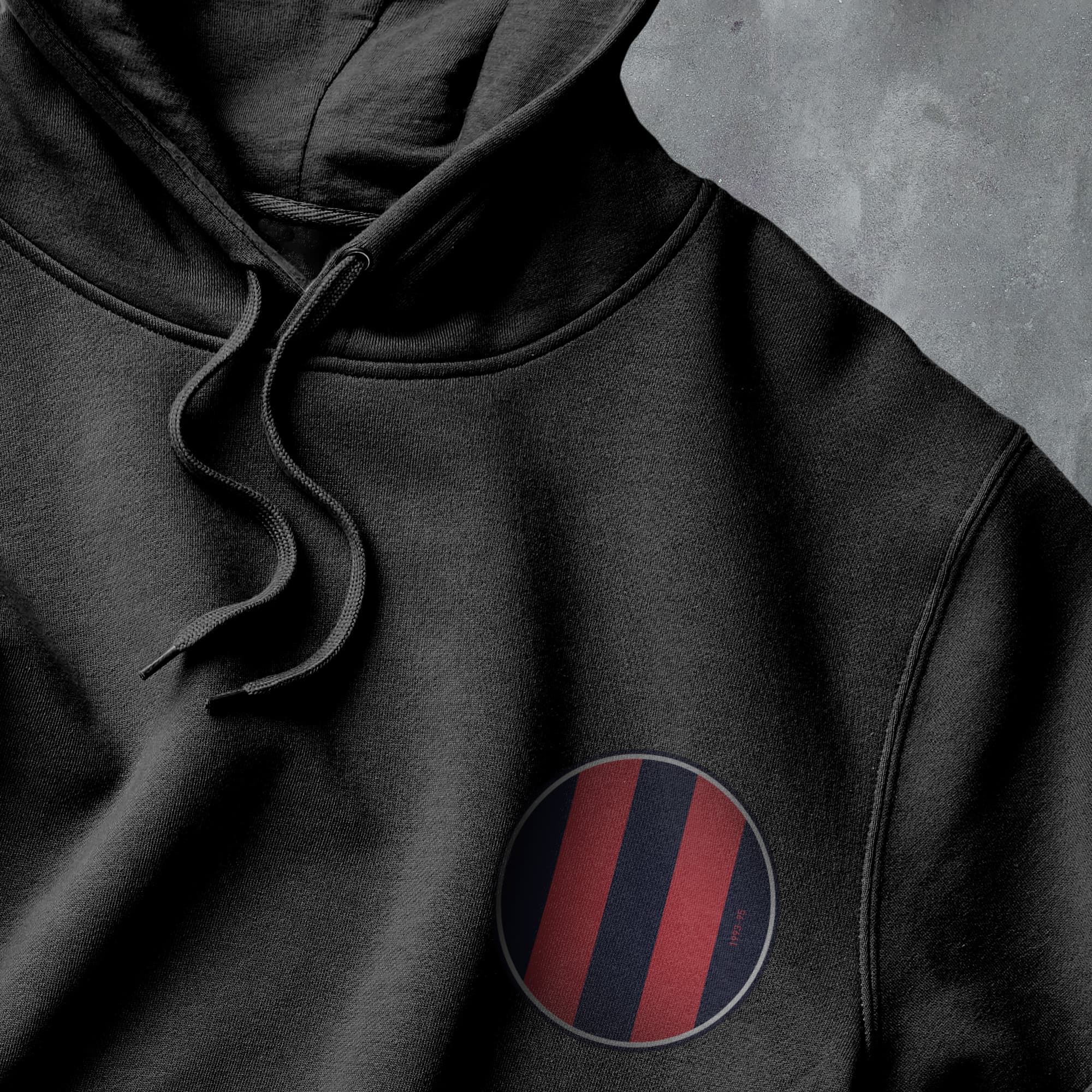 a black hoodie with a red and blue stripe on it