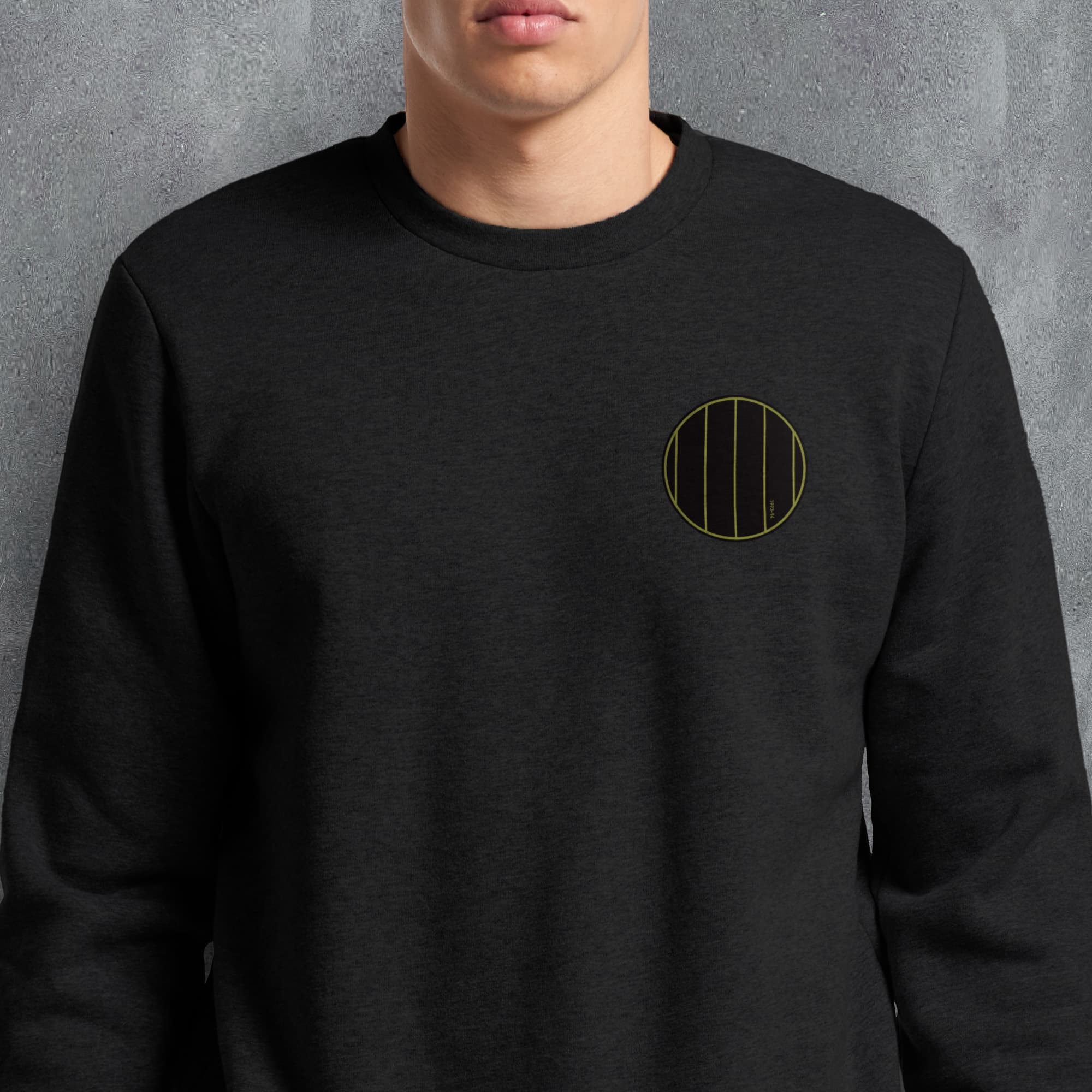 a man wearing a black sweatshirt with a yellow circle on it