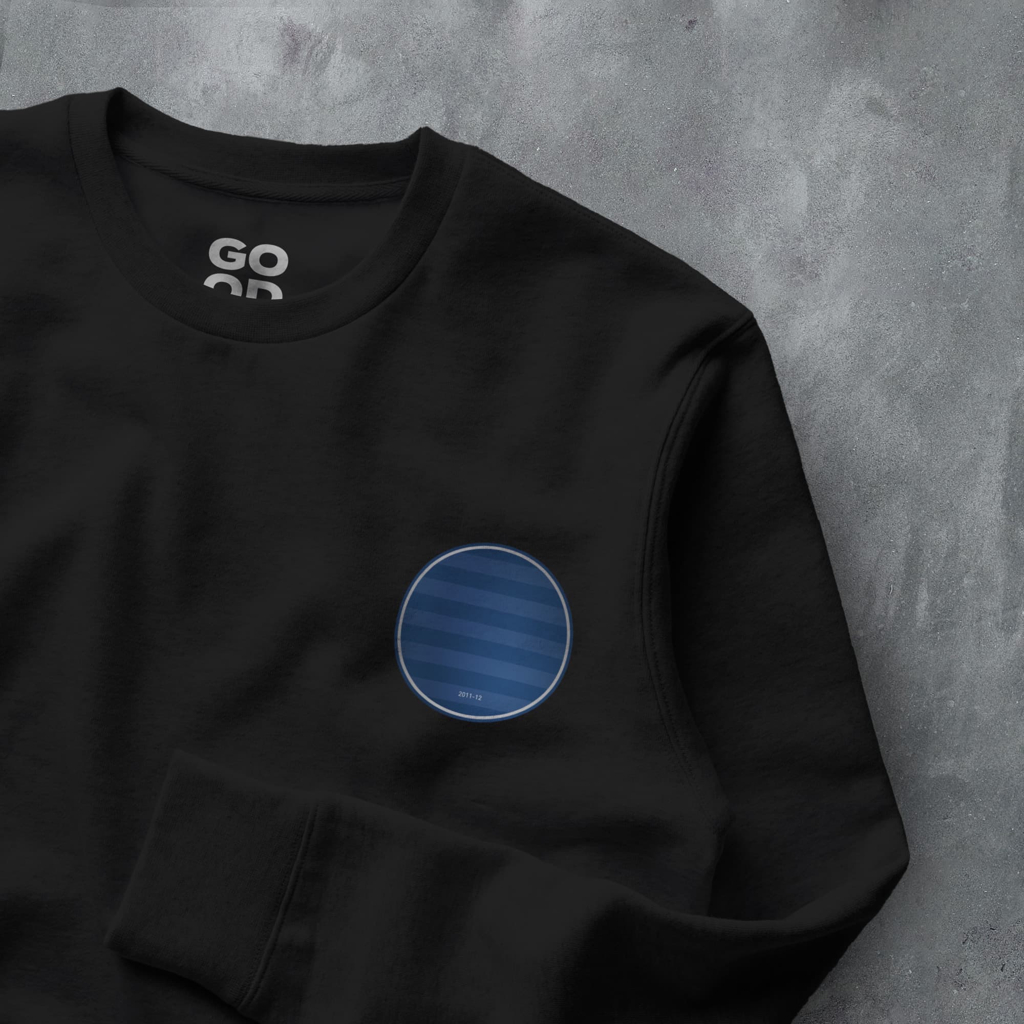 a black sweatshirt with a blue circle on it