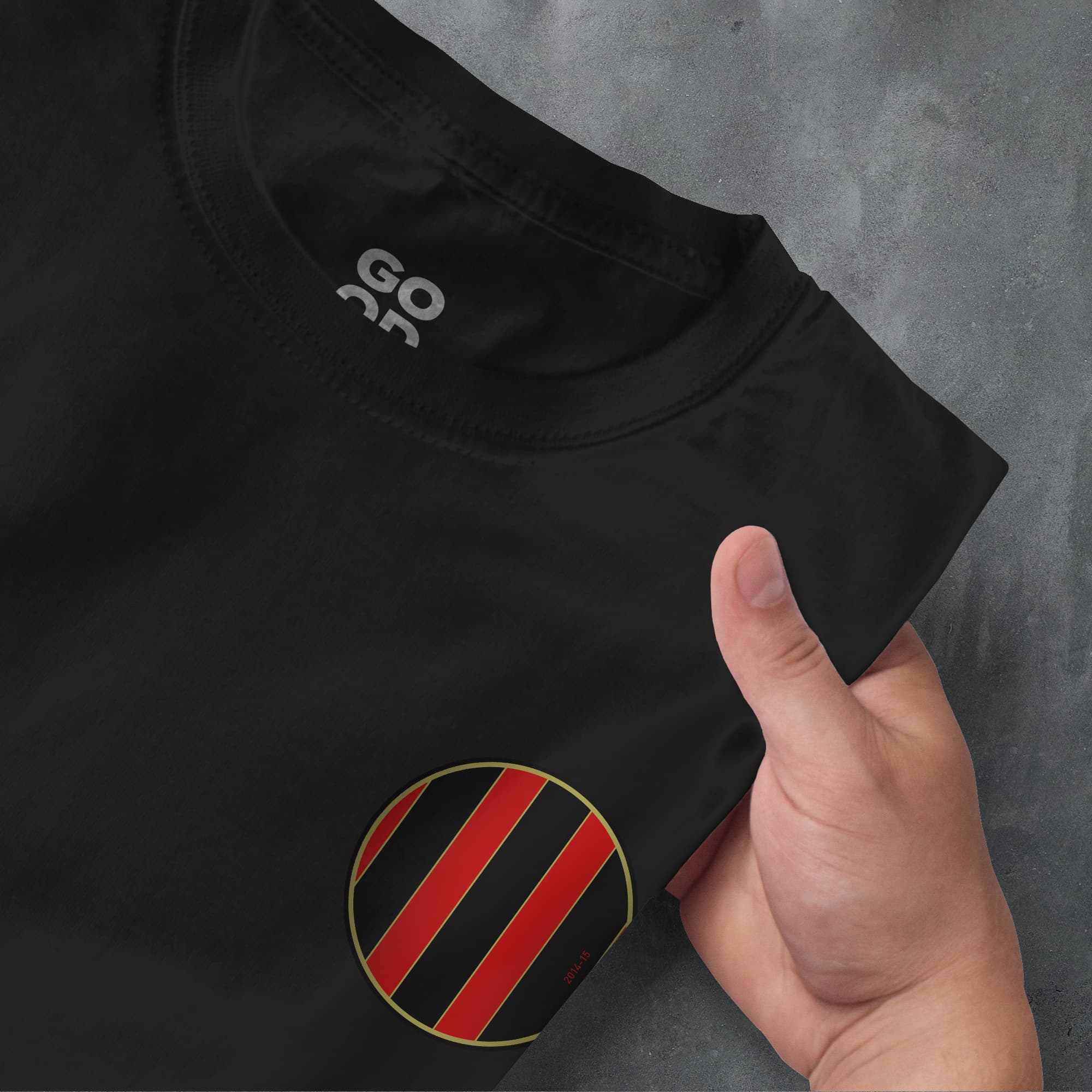 a hand pointing at a black shirt with red and black stripes