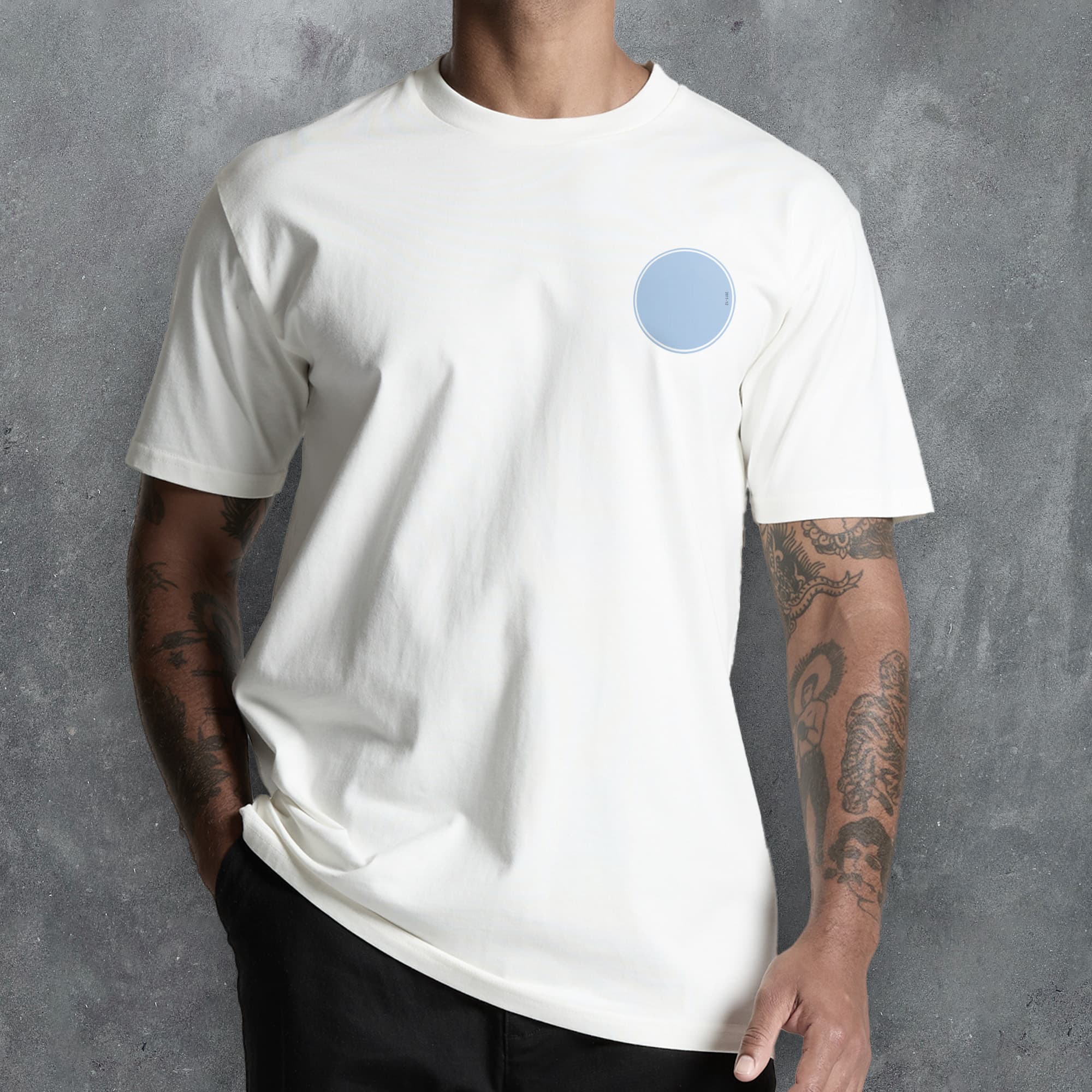 a man wearing a white t - shirt with a blue circle on it