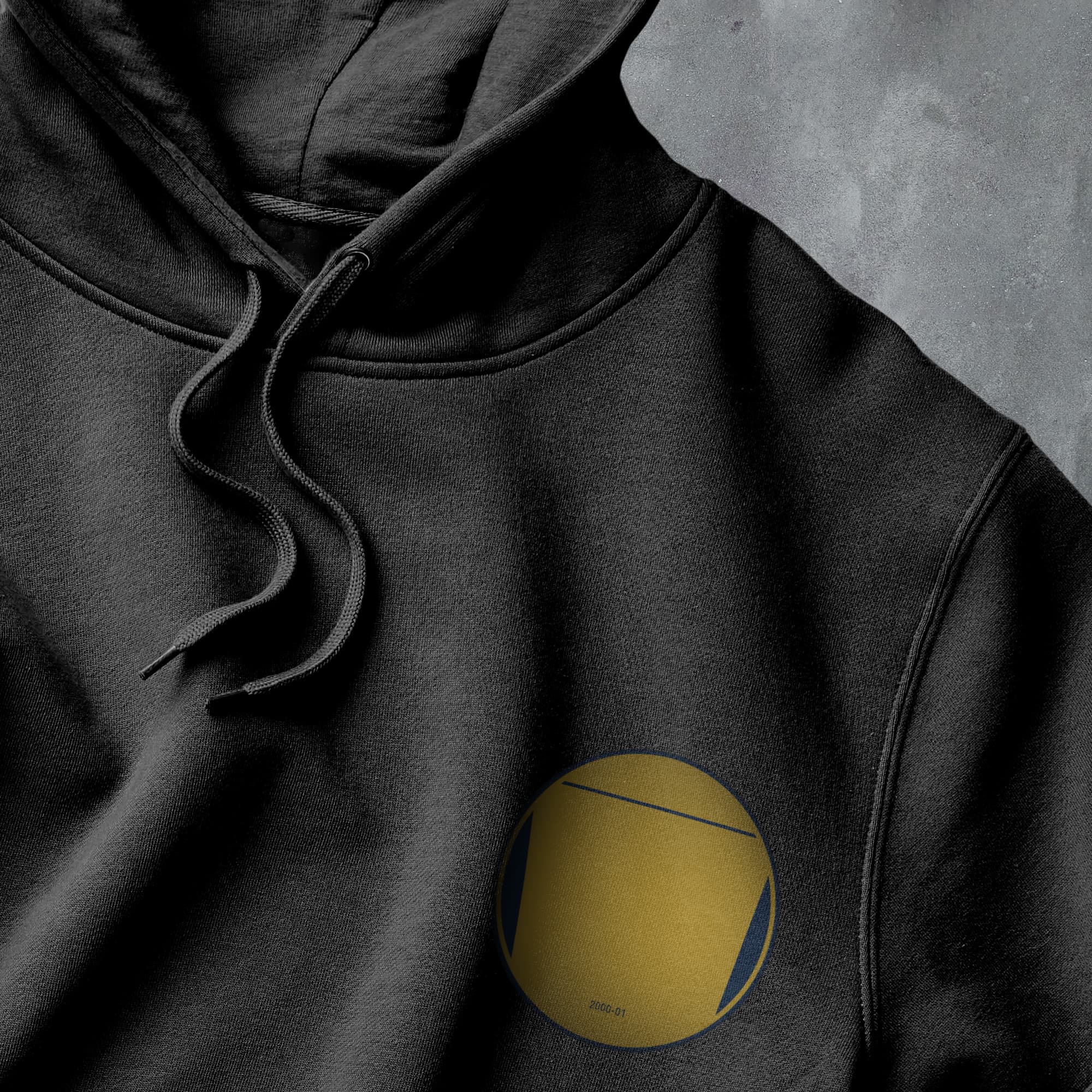a black hoodie with a yellow circle on it