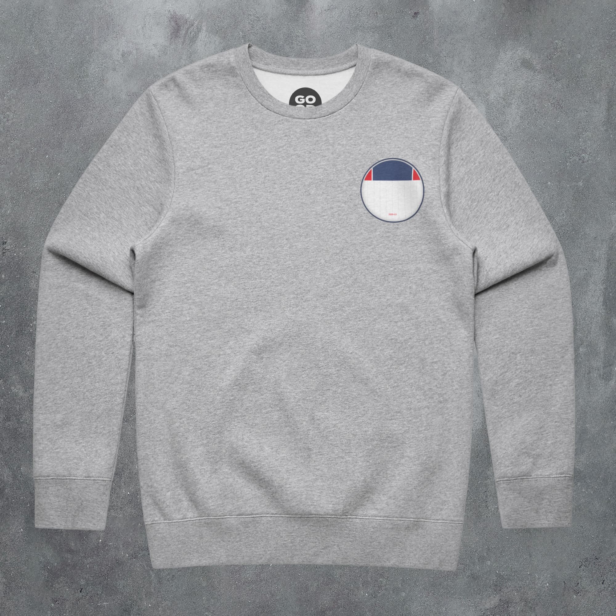 a grey sweatshirt with a white and blue patch on the chest