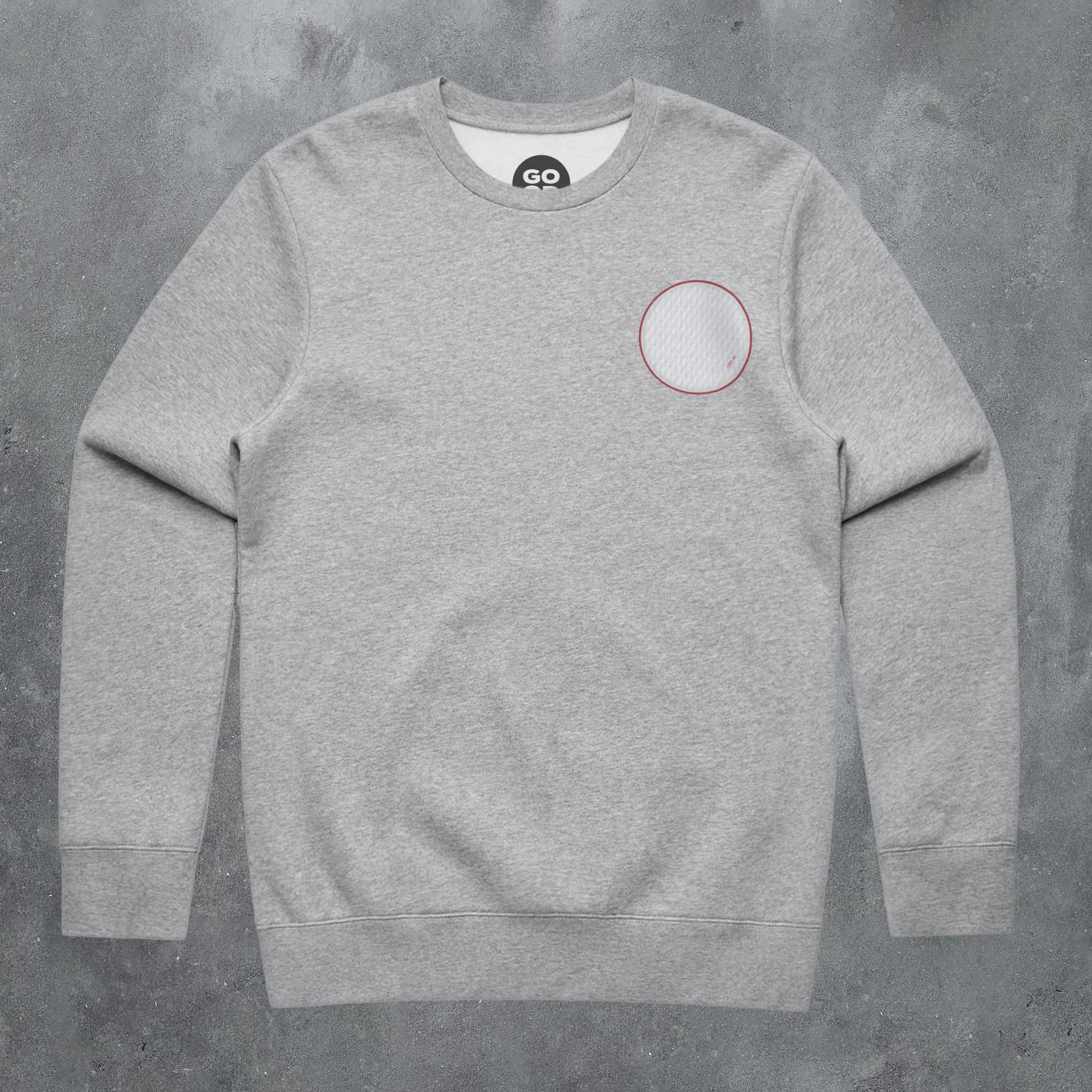 a grey sweatshirt with a red circle on the chest