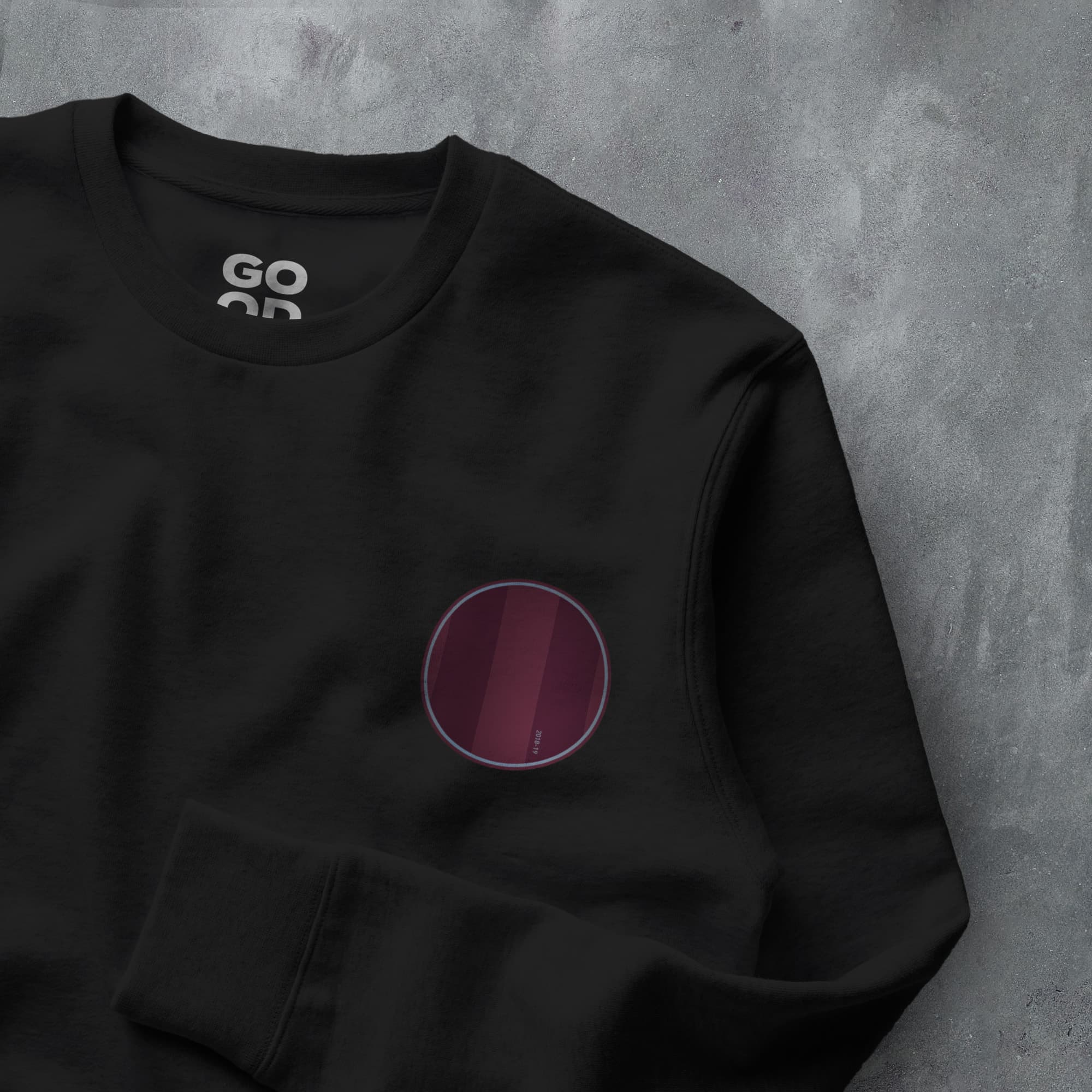 a black sweatshirt with a purple circle on it