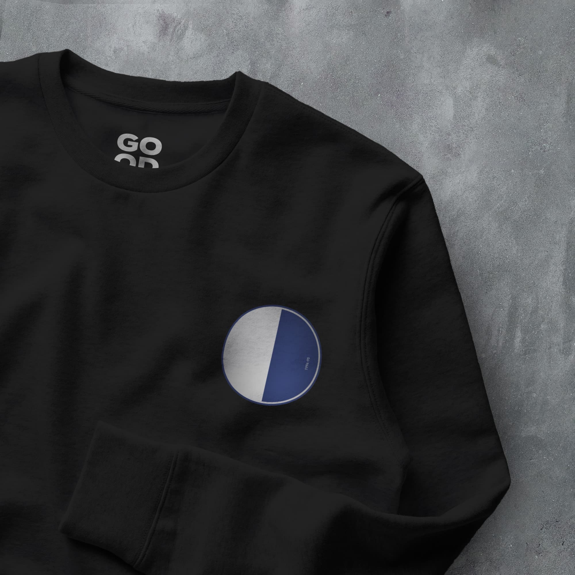 a black sweatshirt with a blue and white circle on it