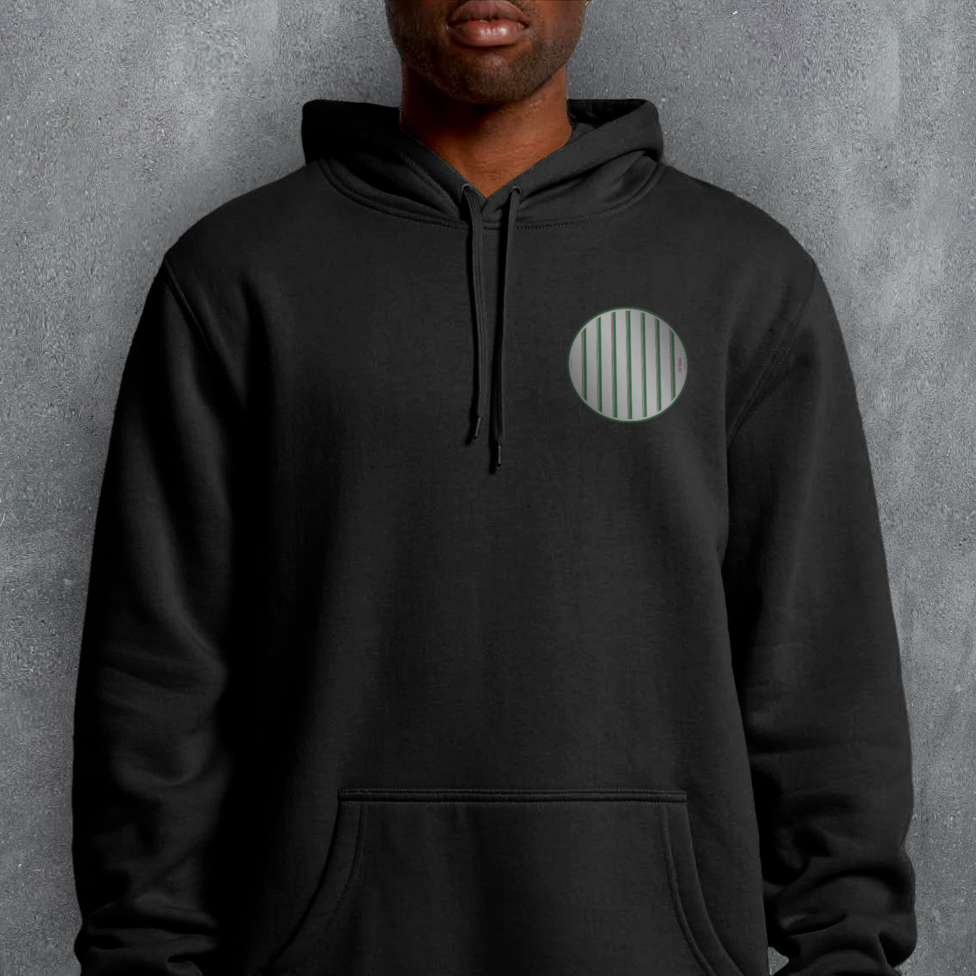 a man wearing a black hoodie with a green circle on it