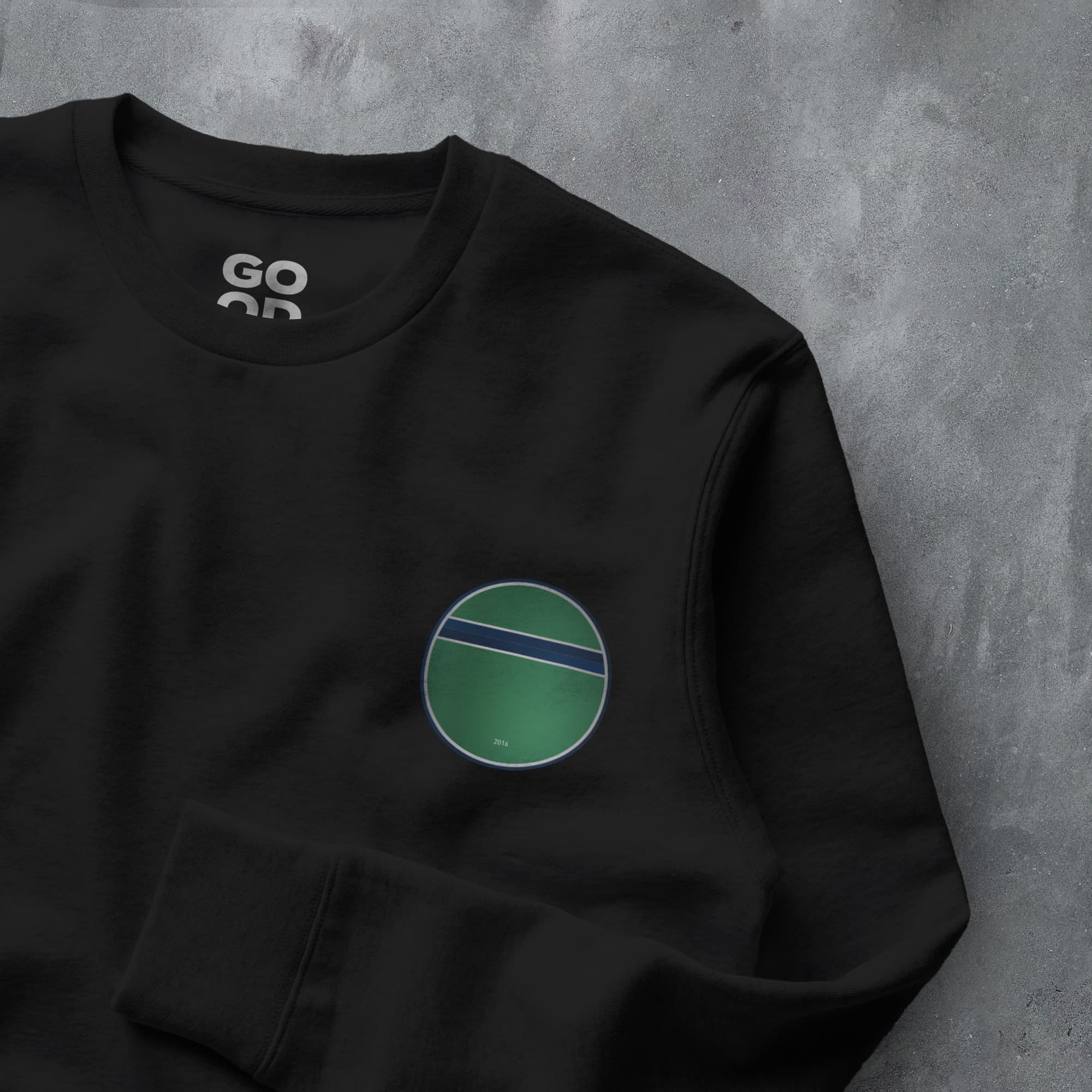 a black sweatshirt with a green circle on it