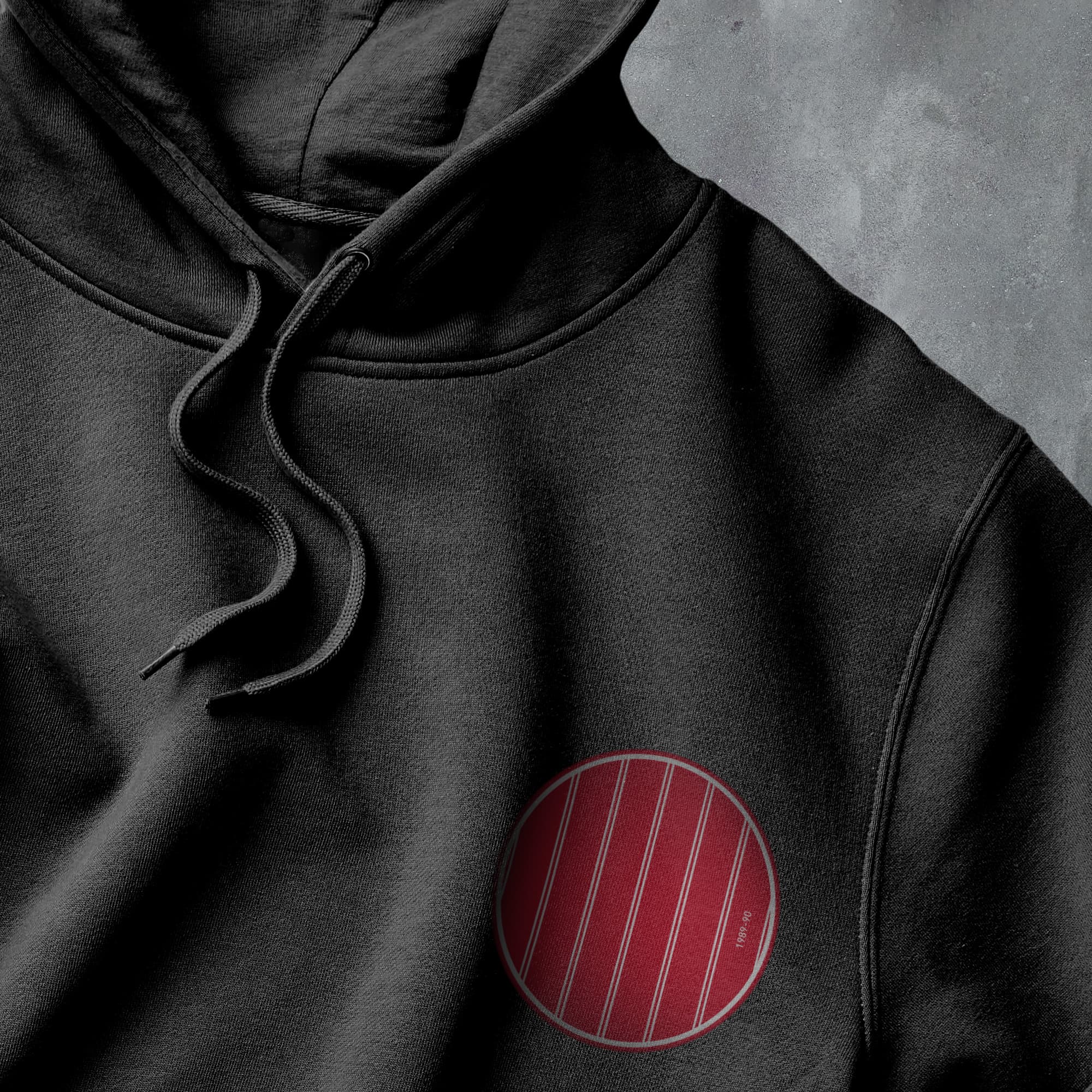 a black hoodie with a red circle on it