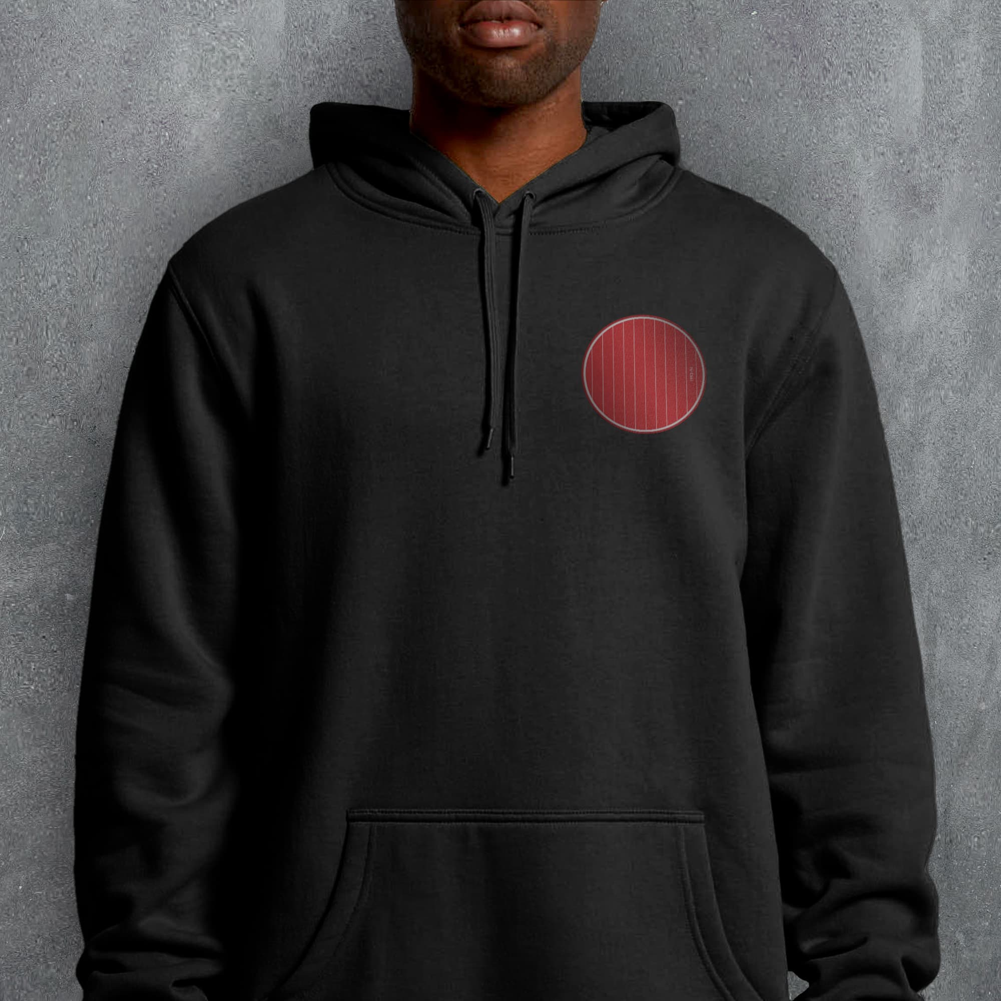 a man wearing a black hoodie with a red circle on it