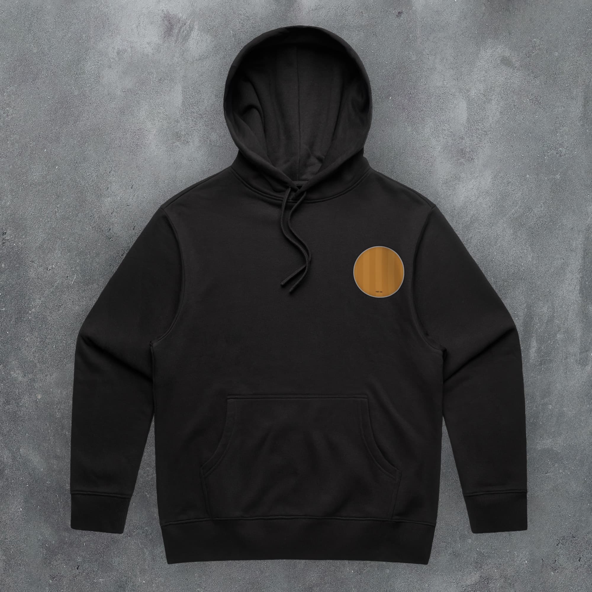 a black hoodie with an orange circle on the front
