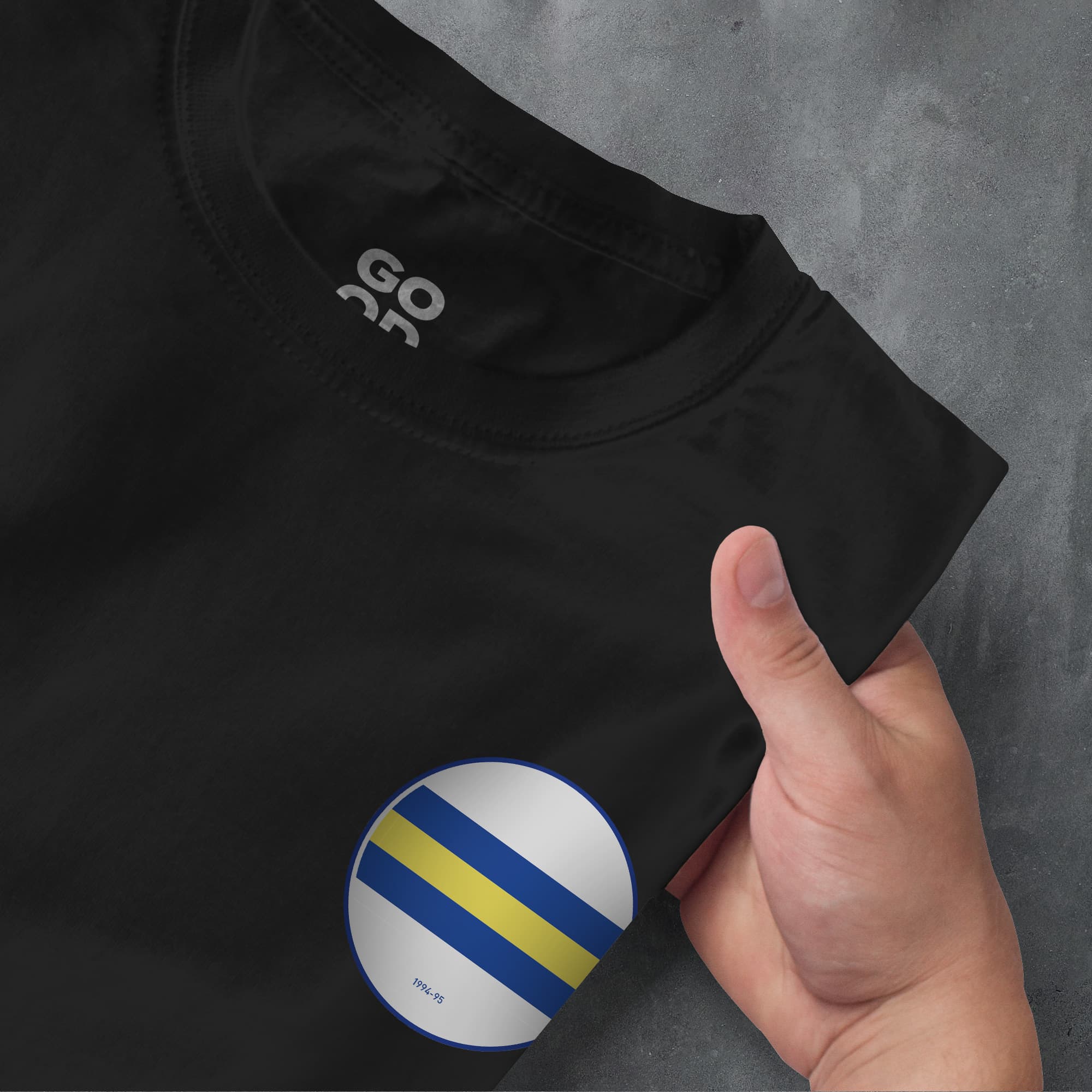 a person pointing at a shirt with a flag on it