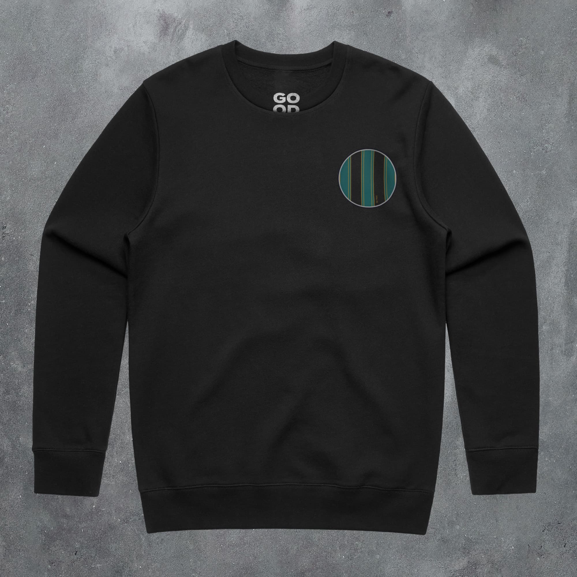a black sweatshirt with a green circle on the front