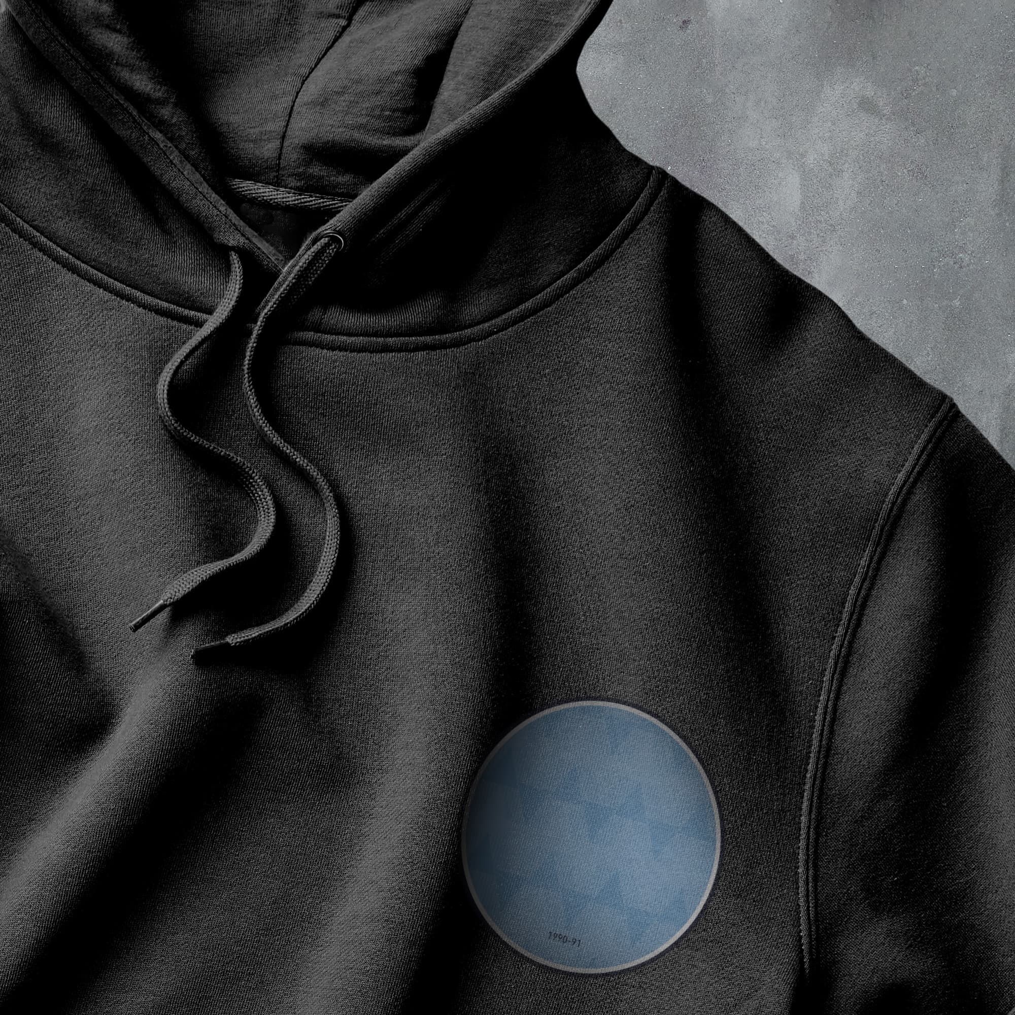 a black hoodie with a blue circle on it