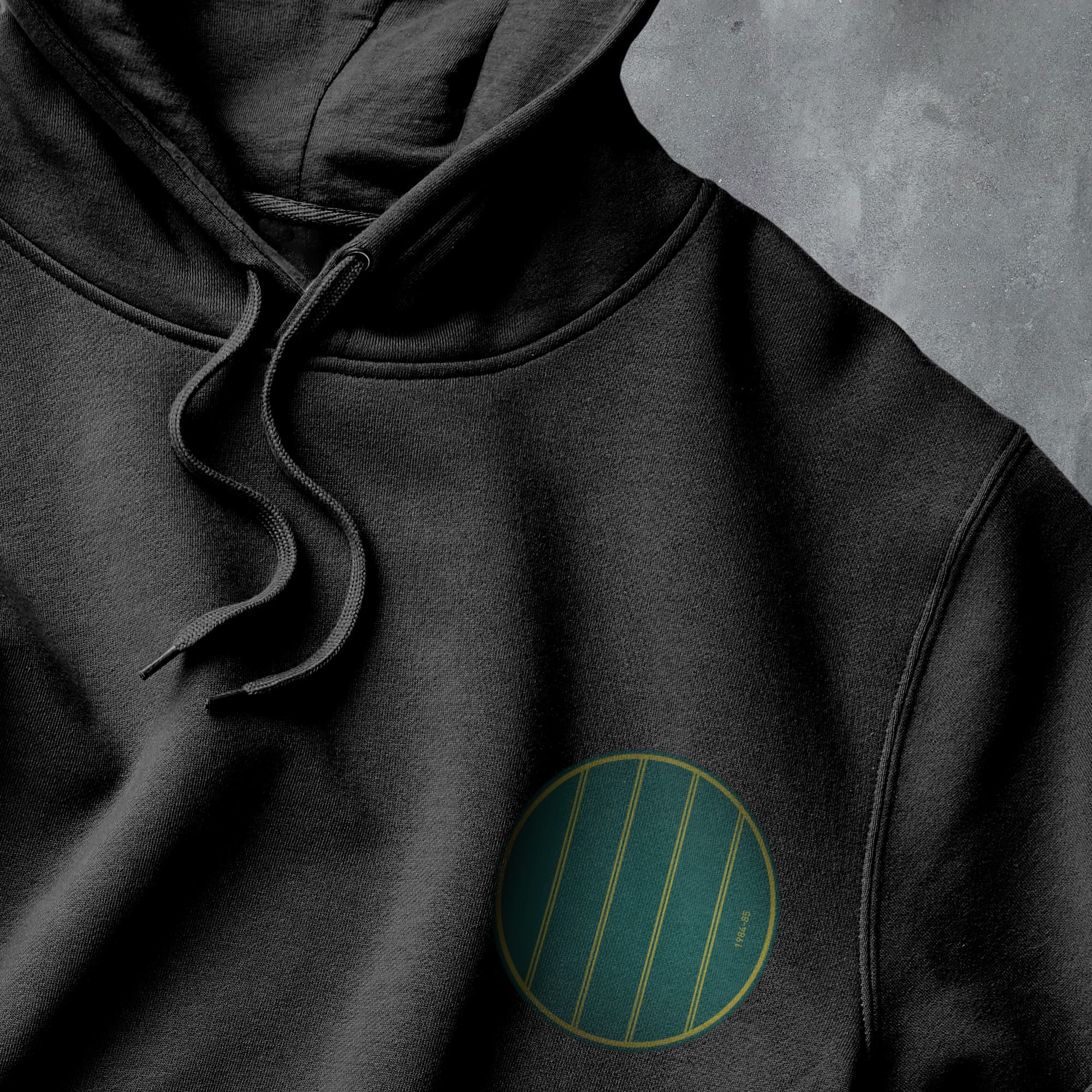 a black hoodie with a green circle on it