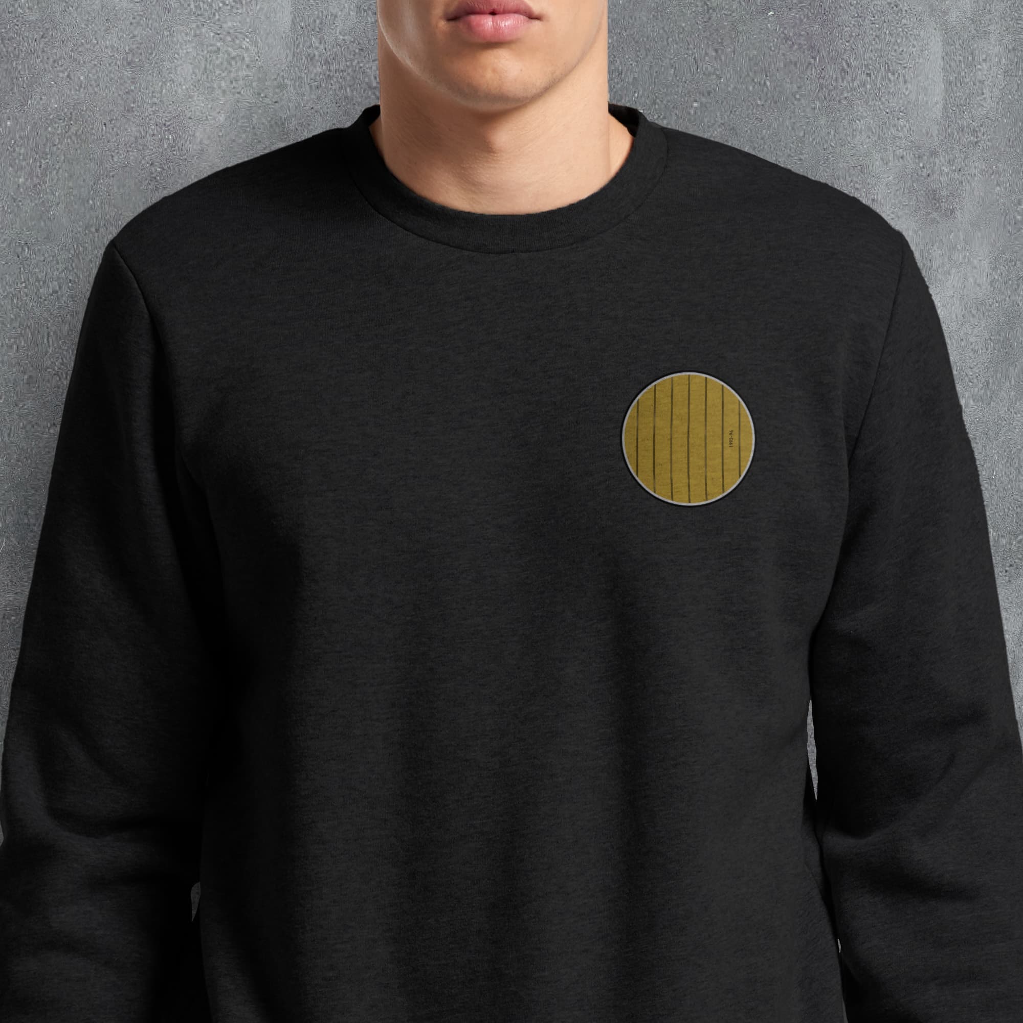 a man wearing a black sweatshirt with a yellow circle on it