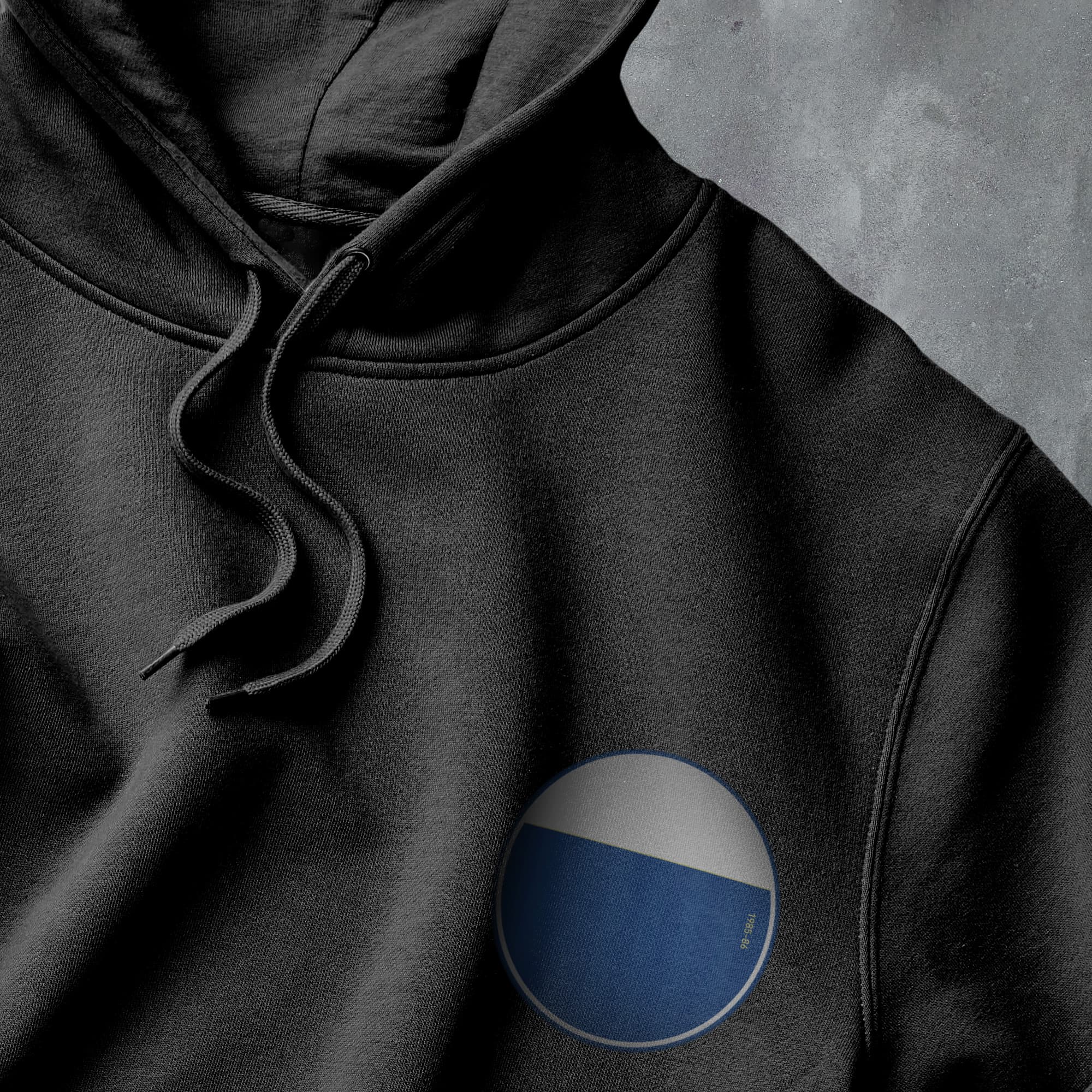 a black hoodie with a blue and white circle on it