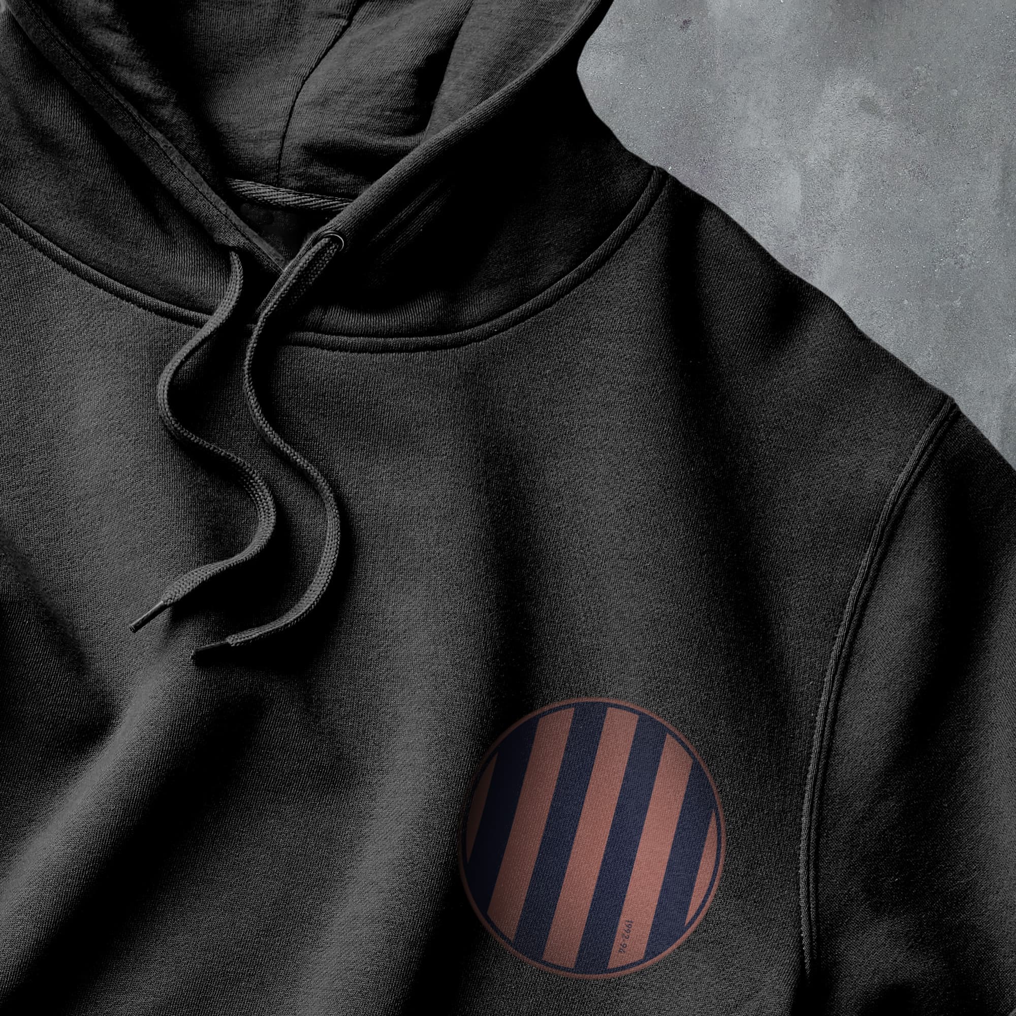 a black hoodie with a red and black stripe on it