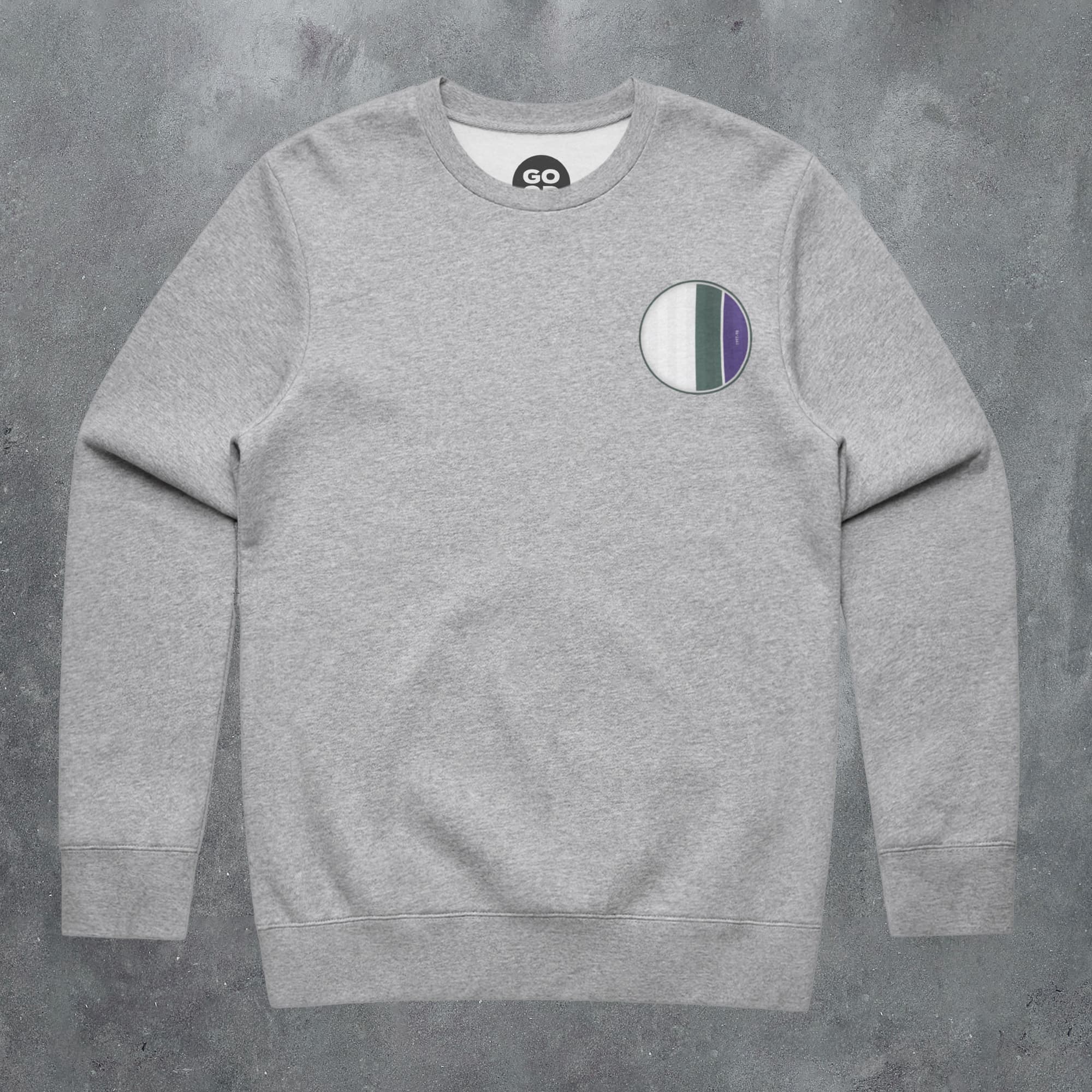 a grey sweatshirt with a green, white and blue patch on the chest