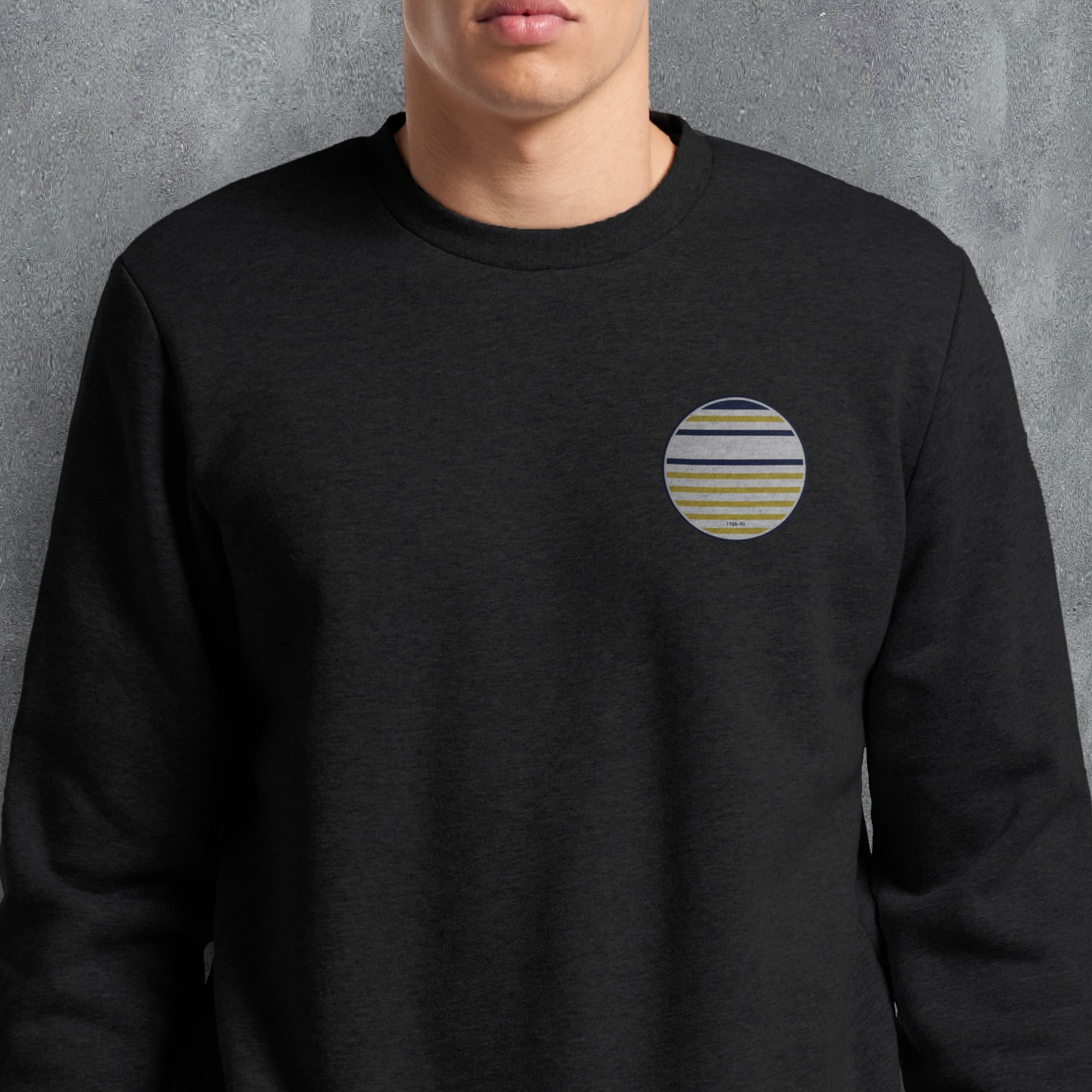 a man wearing a black sweatshirt with a striped pocket