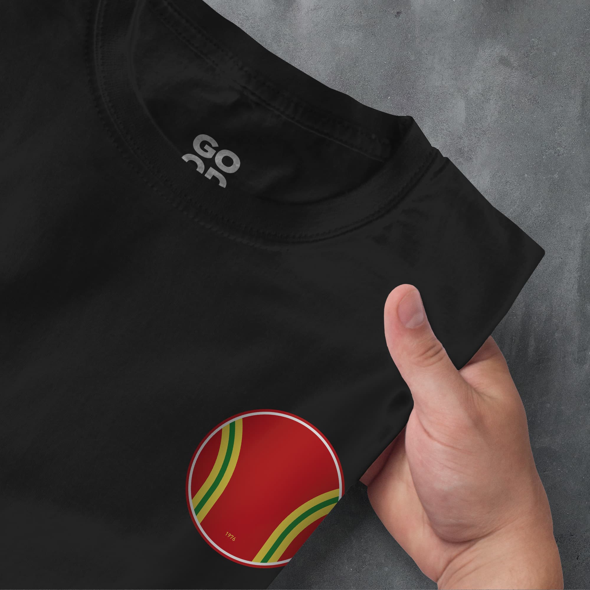 a person pointing at a red and green shirt