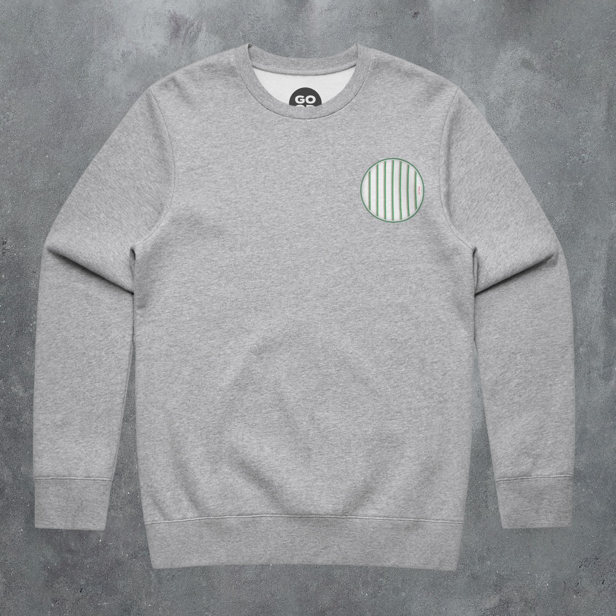 a grey sweatshirt with a green circle on it