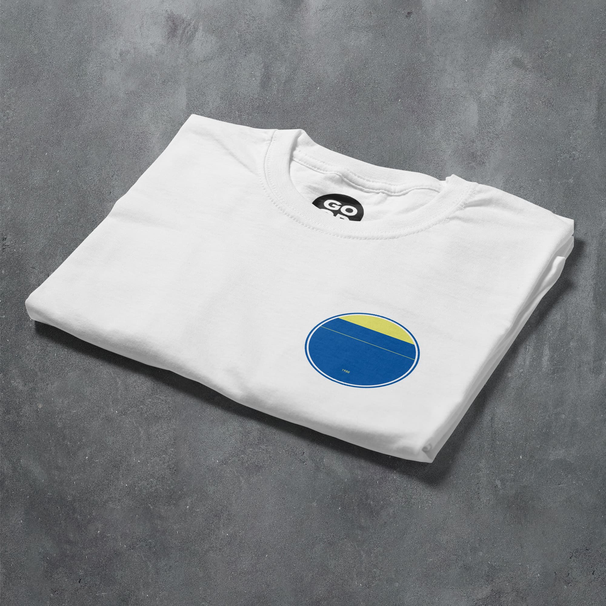 a white t - shirt with a blue and yellow circle on it