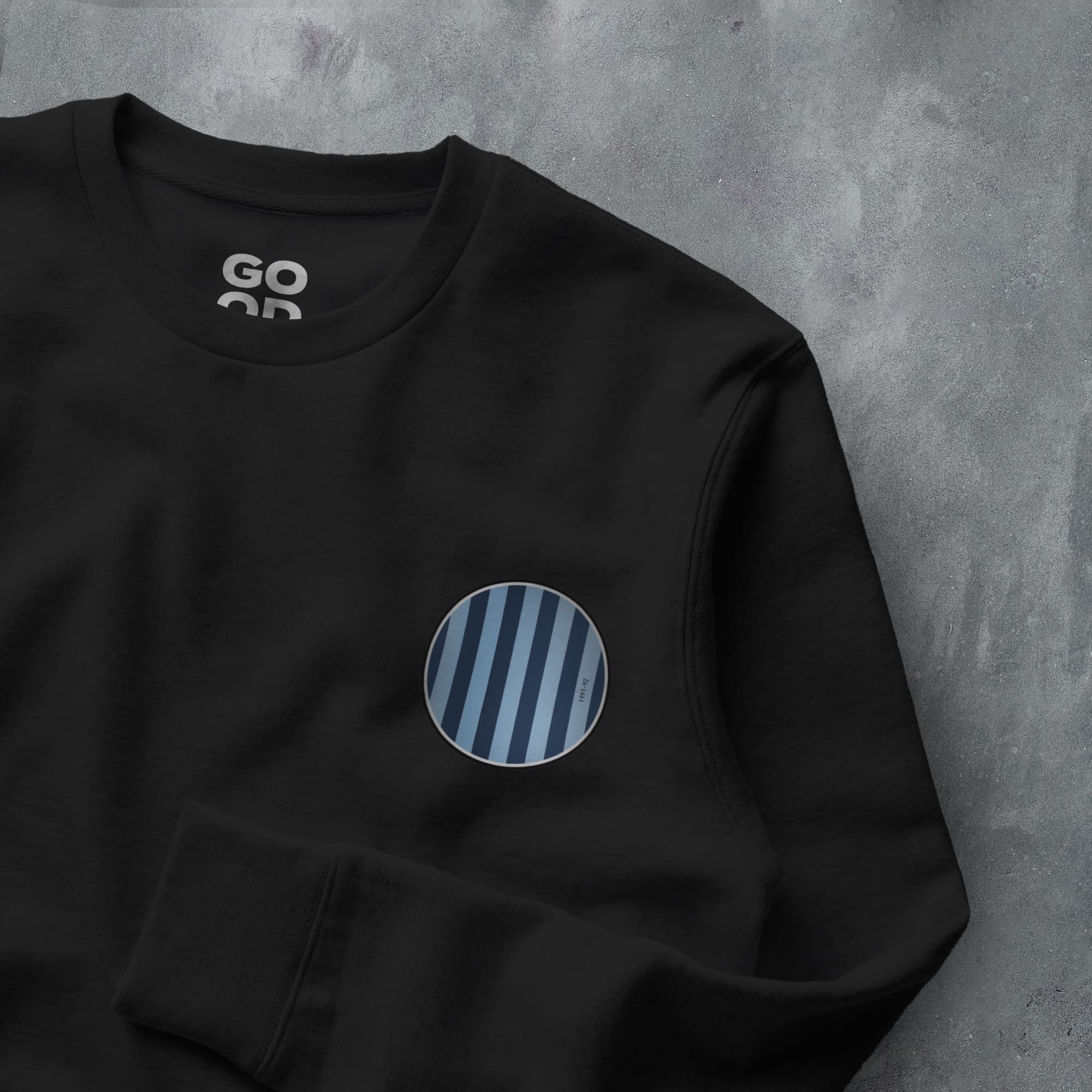 a black sweatshirt with a blue and white circle on it