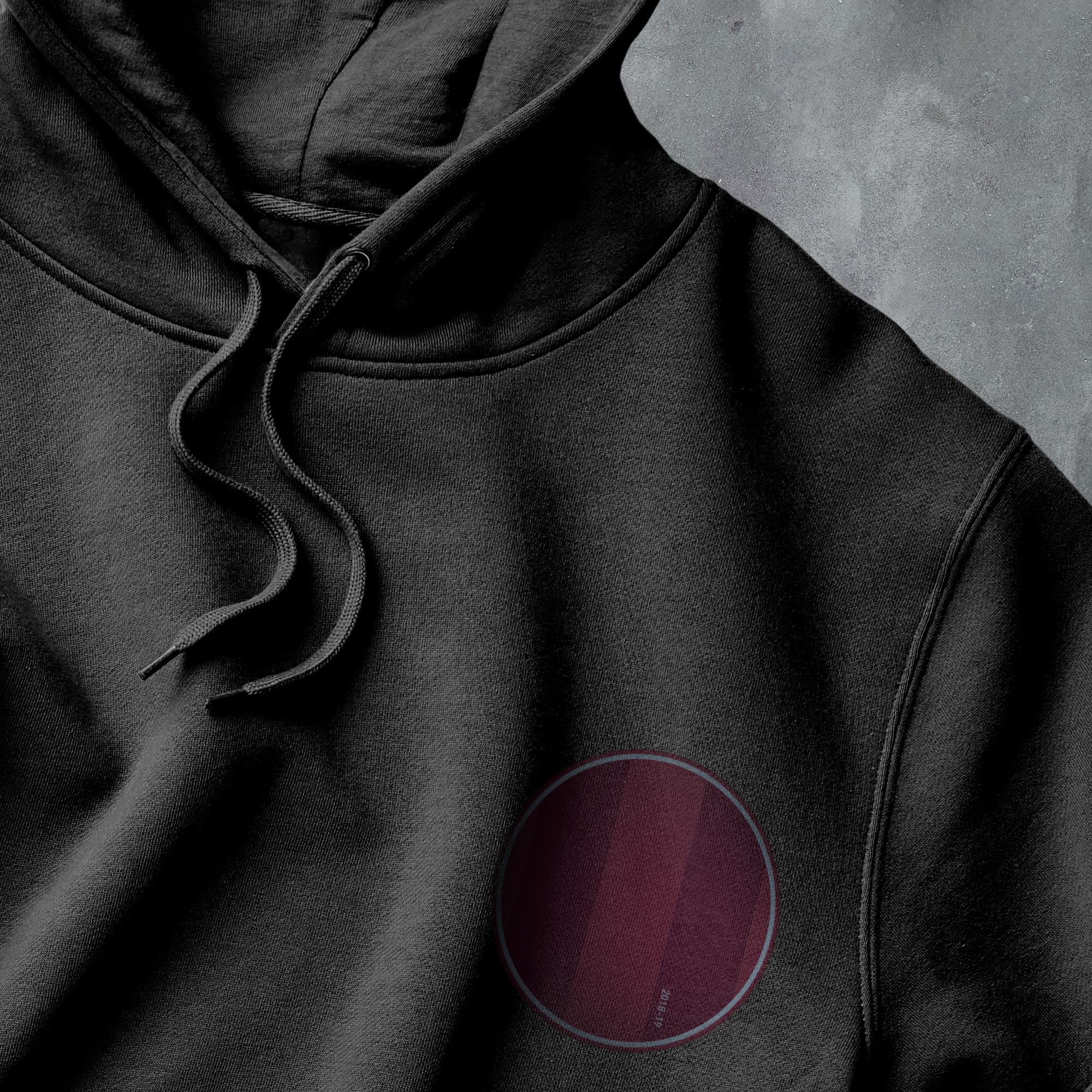 a black hoodie with a red circle on it