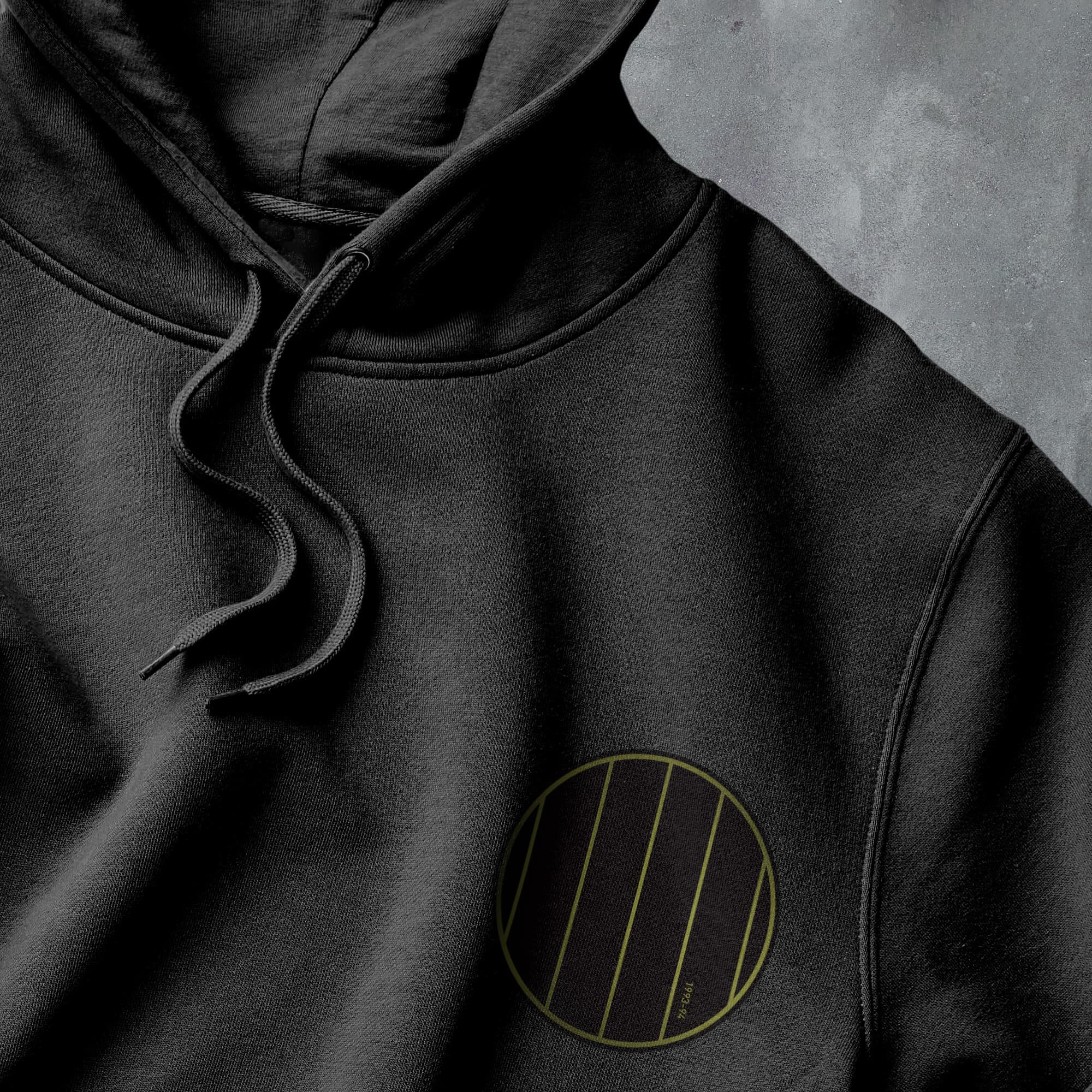 a black hoodie with a yellow circle on it