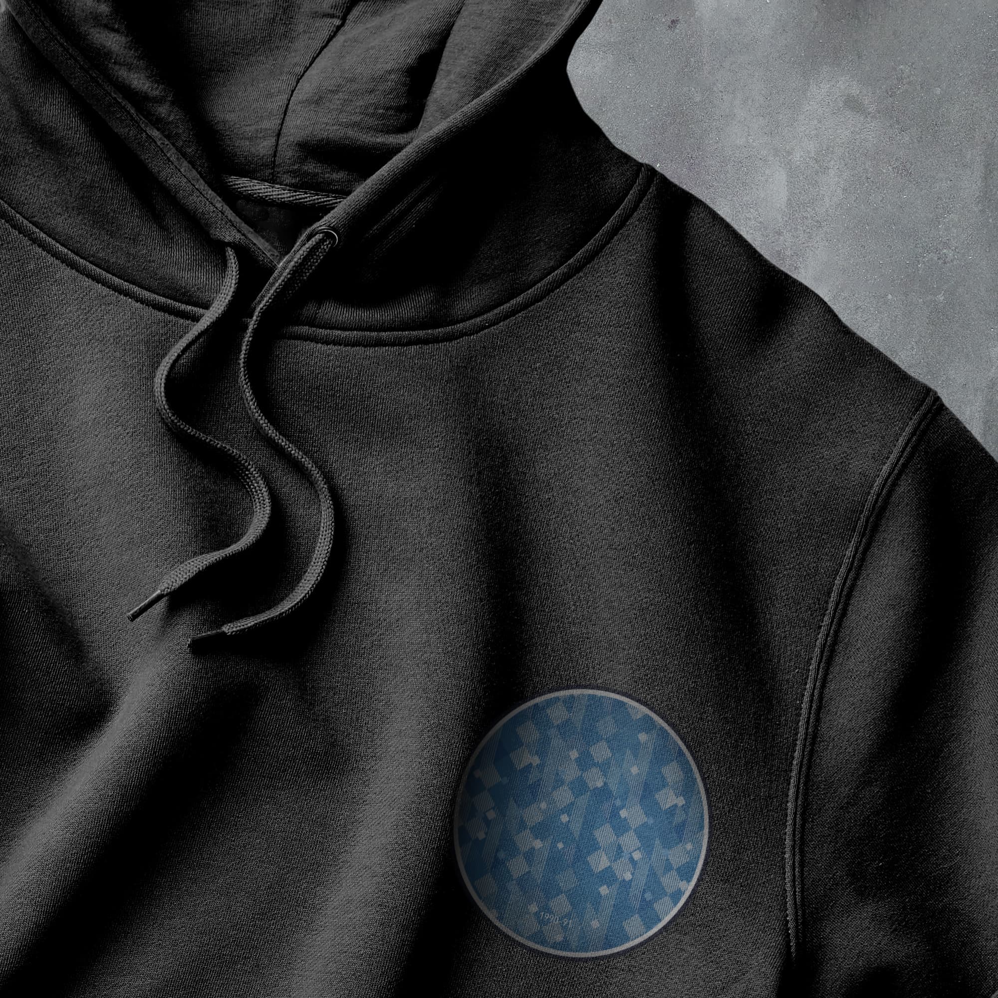 a black hoodie with a blue circle on it