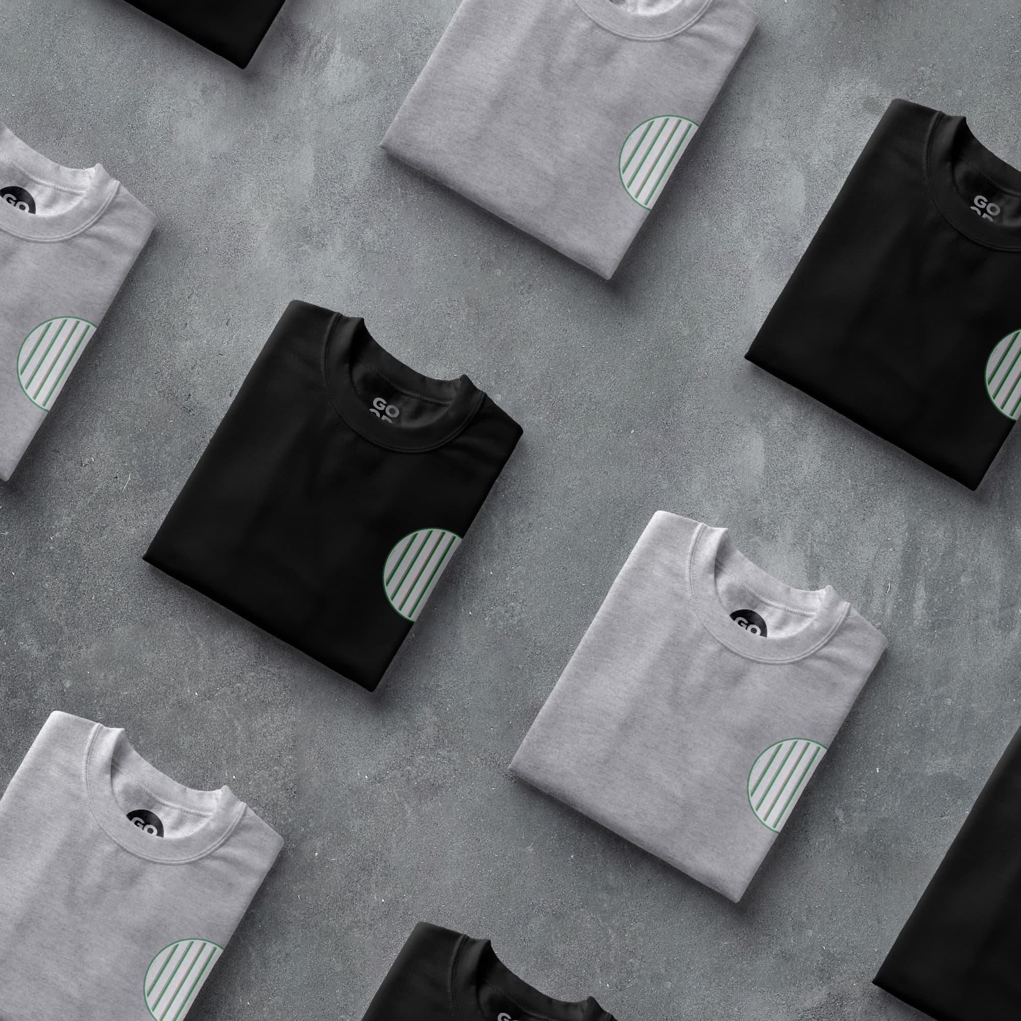a group of t - shirts sitting on top of a cement floor