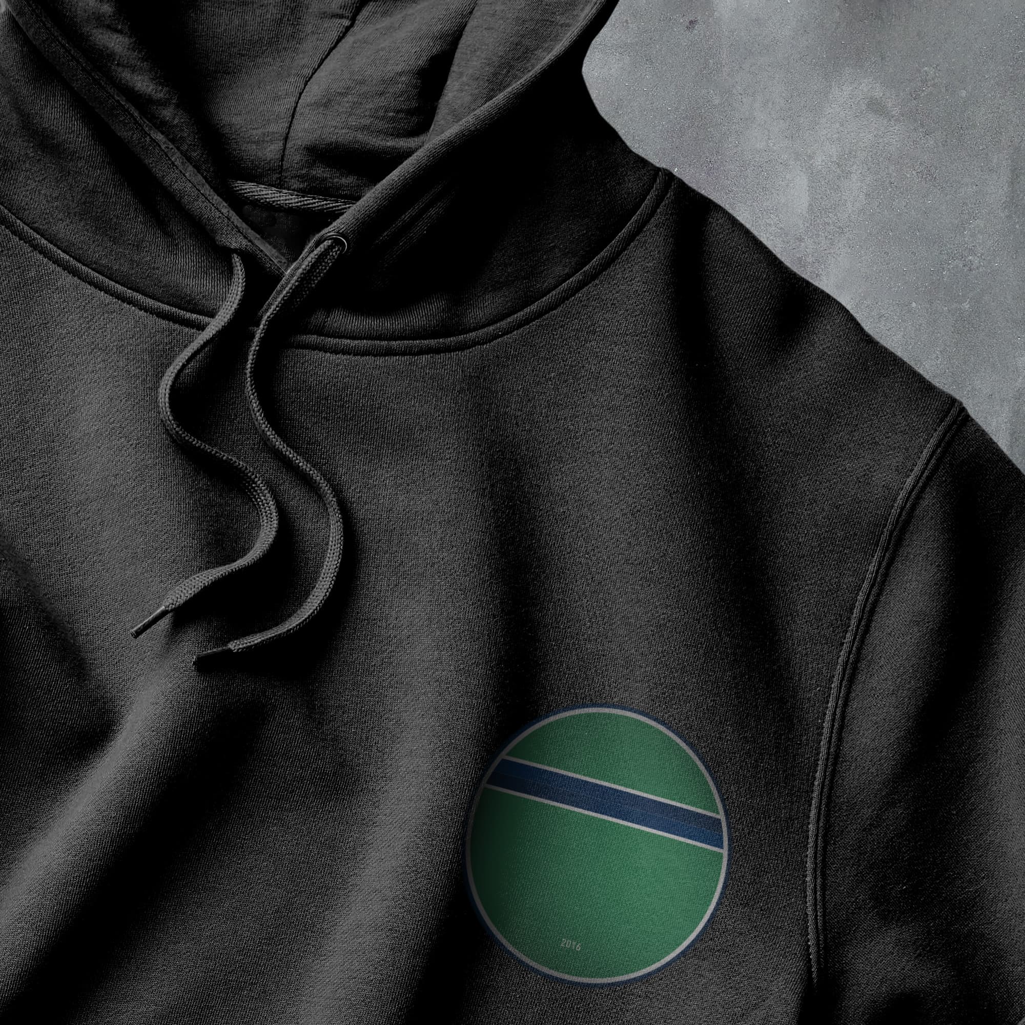 a black hoodie with a green circle on it