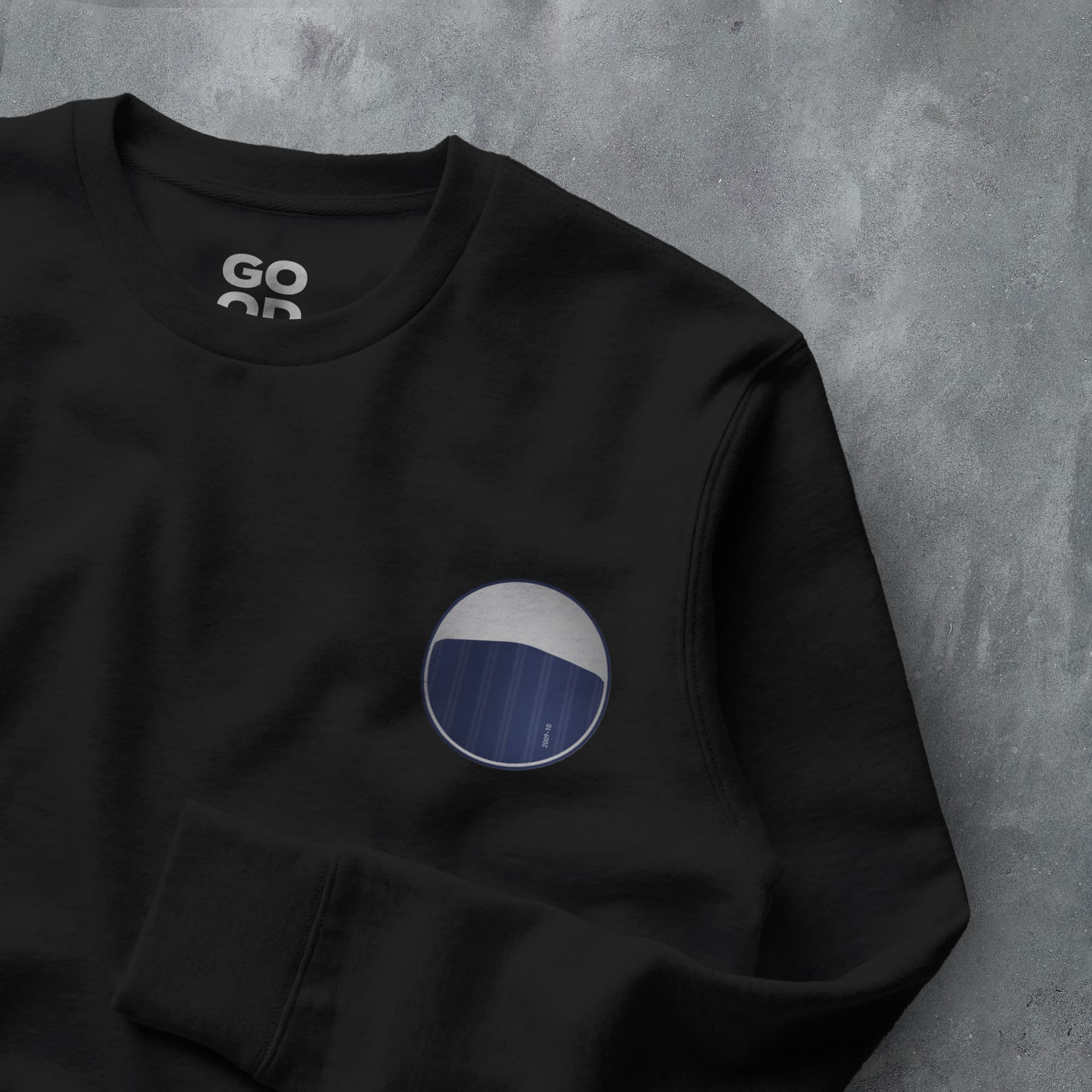 a black sweatshirt with a blue and white circle on it