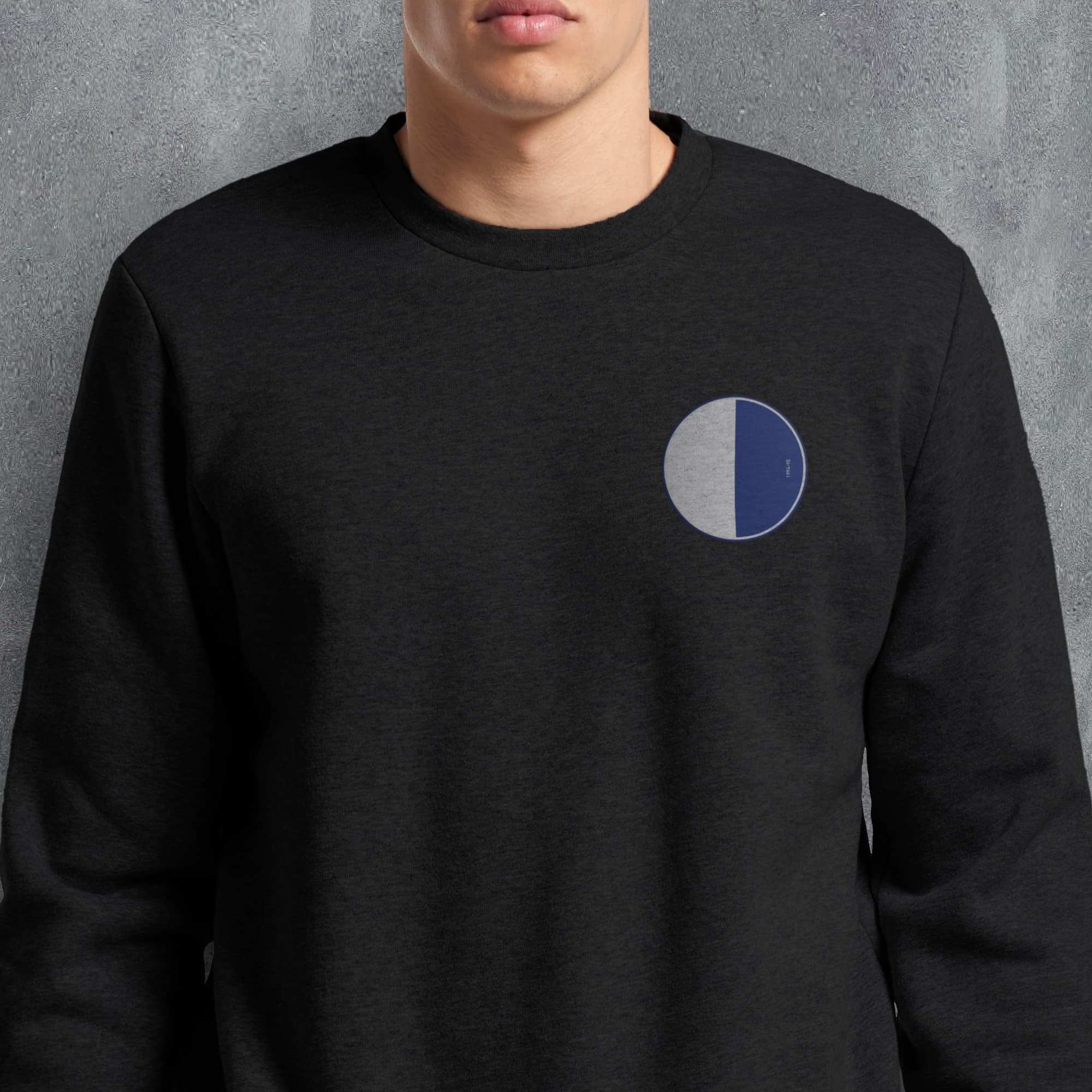 a man wearing a black sweatshirt with a blue circle on it