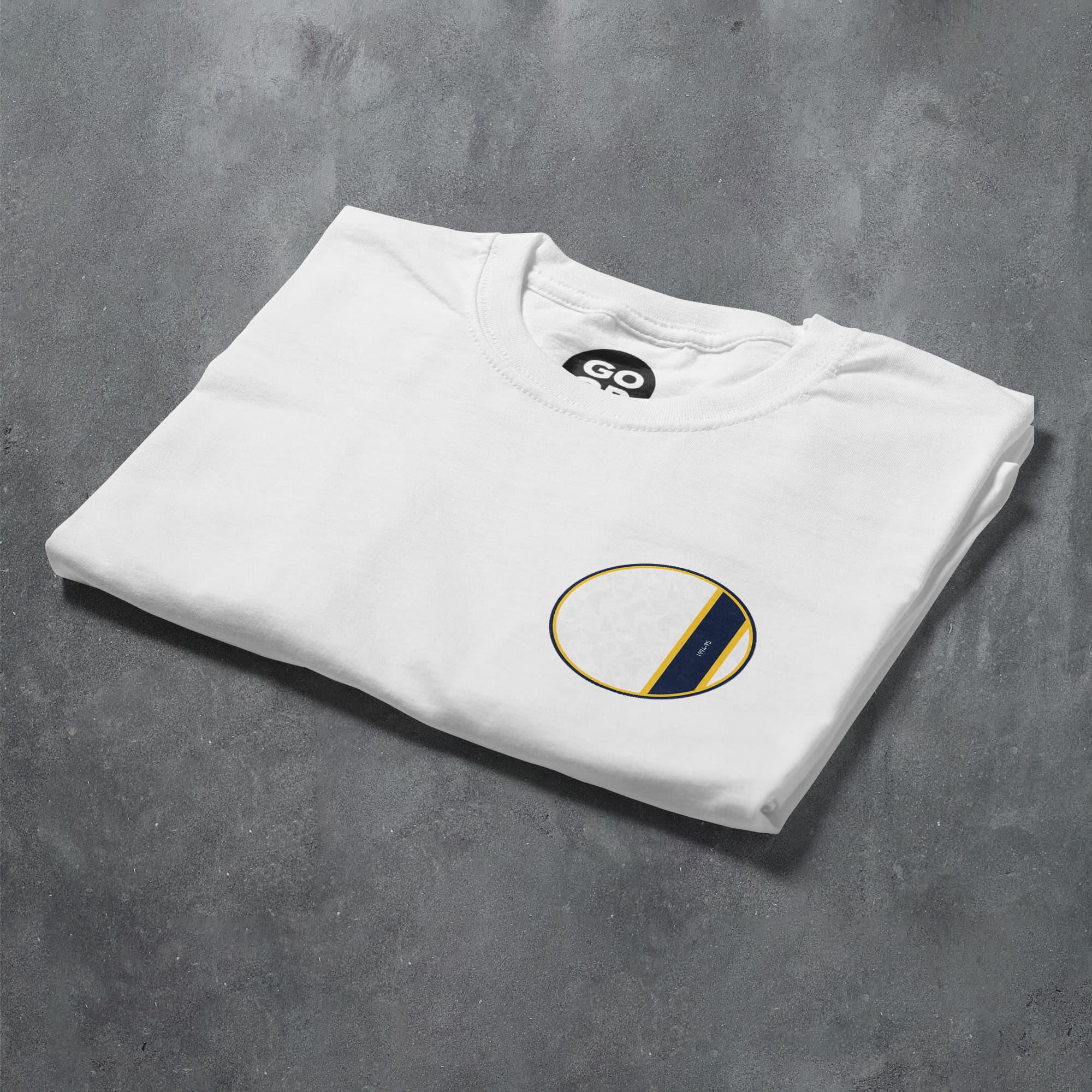 a white t - shirt with a black and yellow circle on it