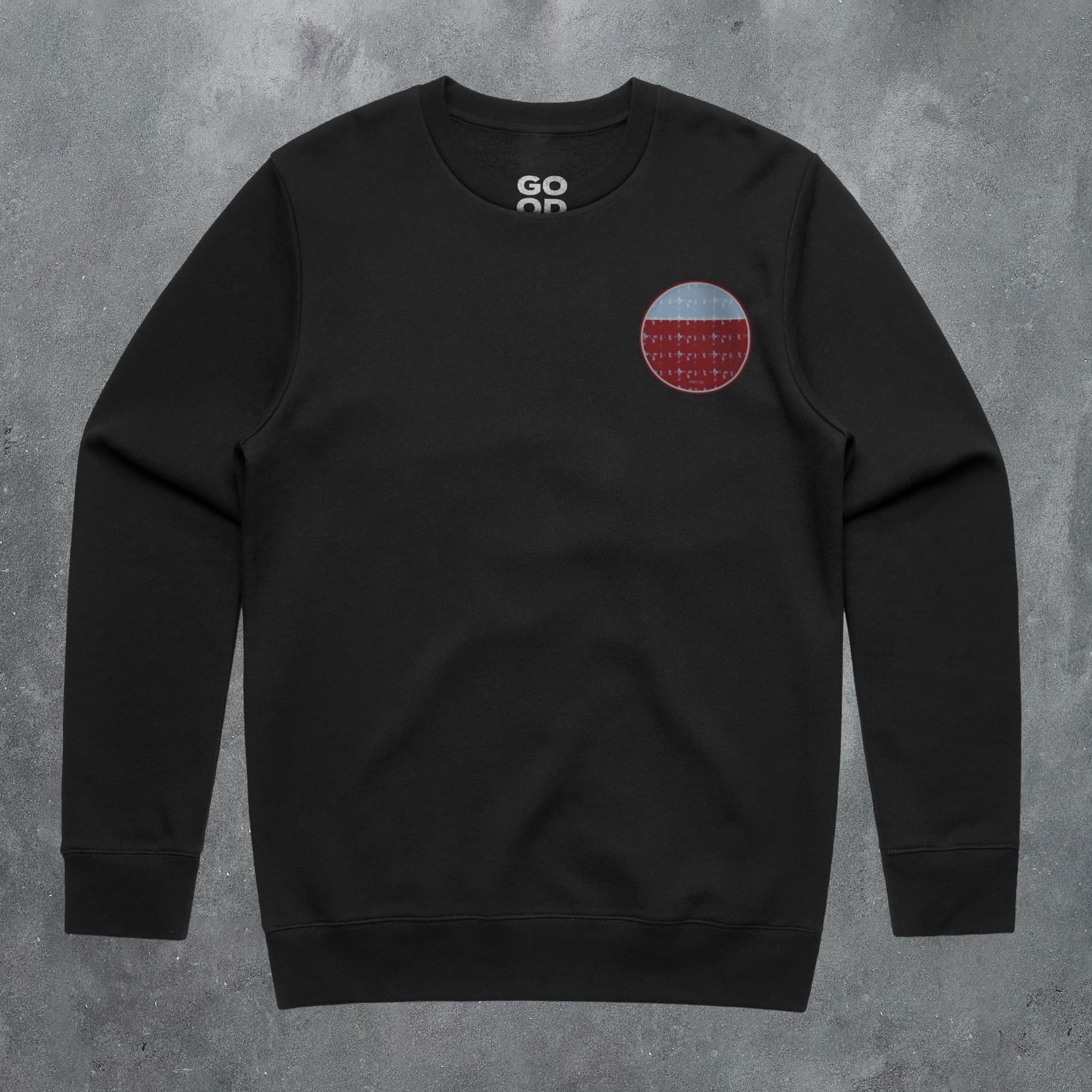 a black sweatshirt with a red and blue patch on the chest