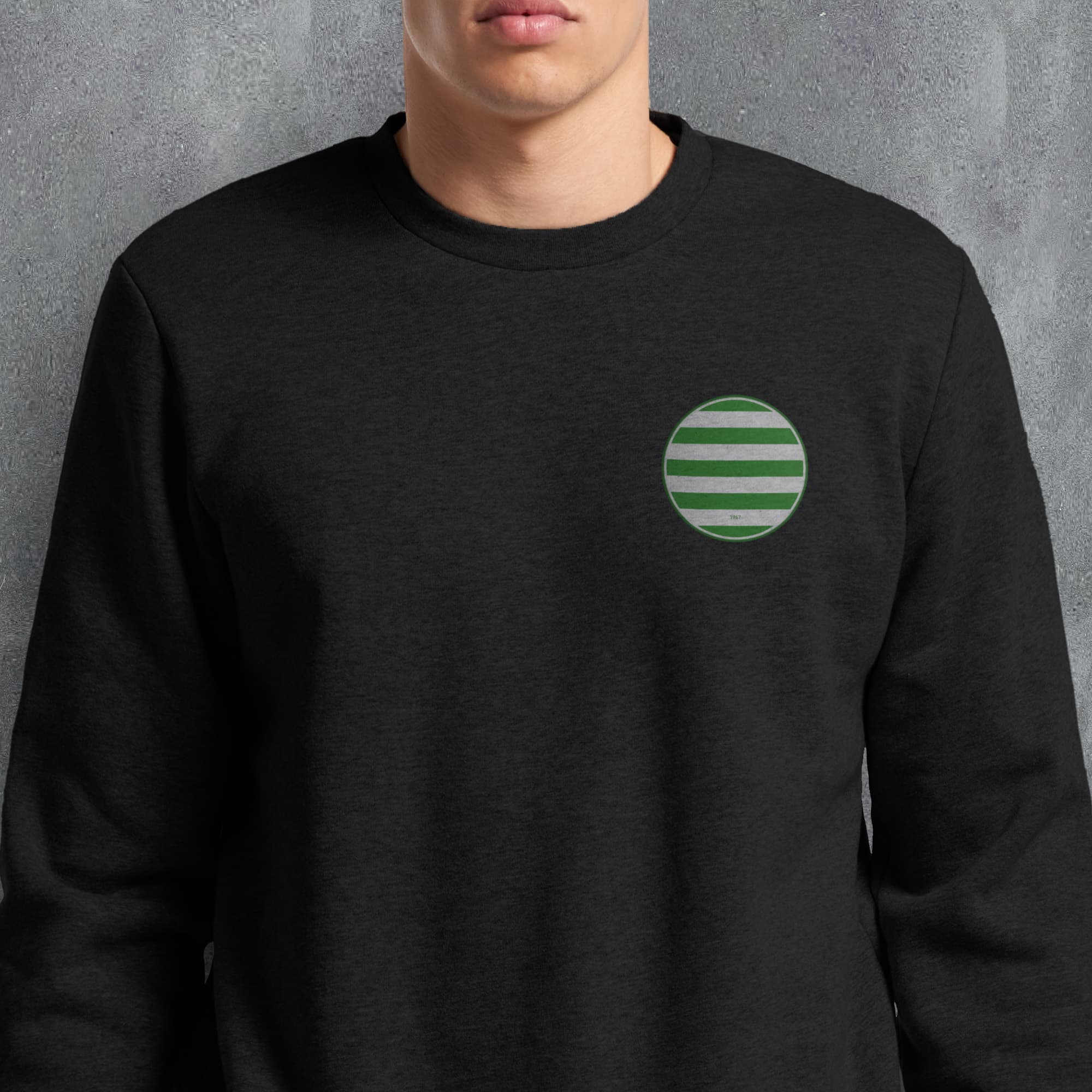 a man wearing a black sweatshirt with a green circle on it